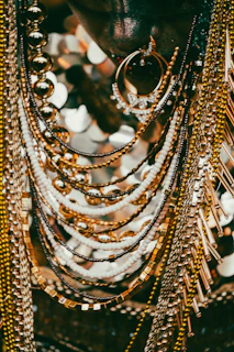 Close-up of layered gold and pearl necklaces