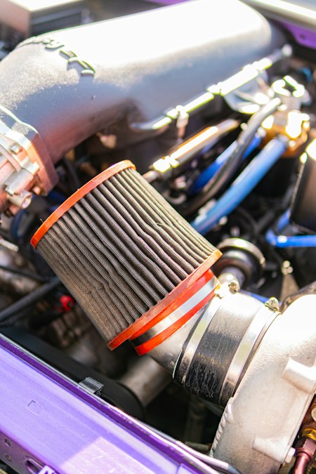 Close-up of a dirty clogged air filter on an engine intake — cleaning/service visual