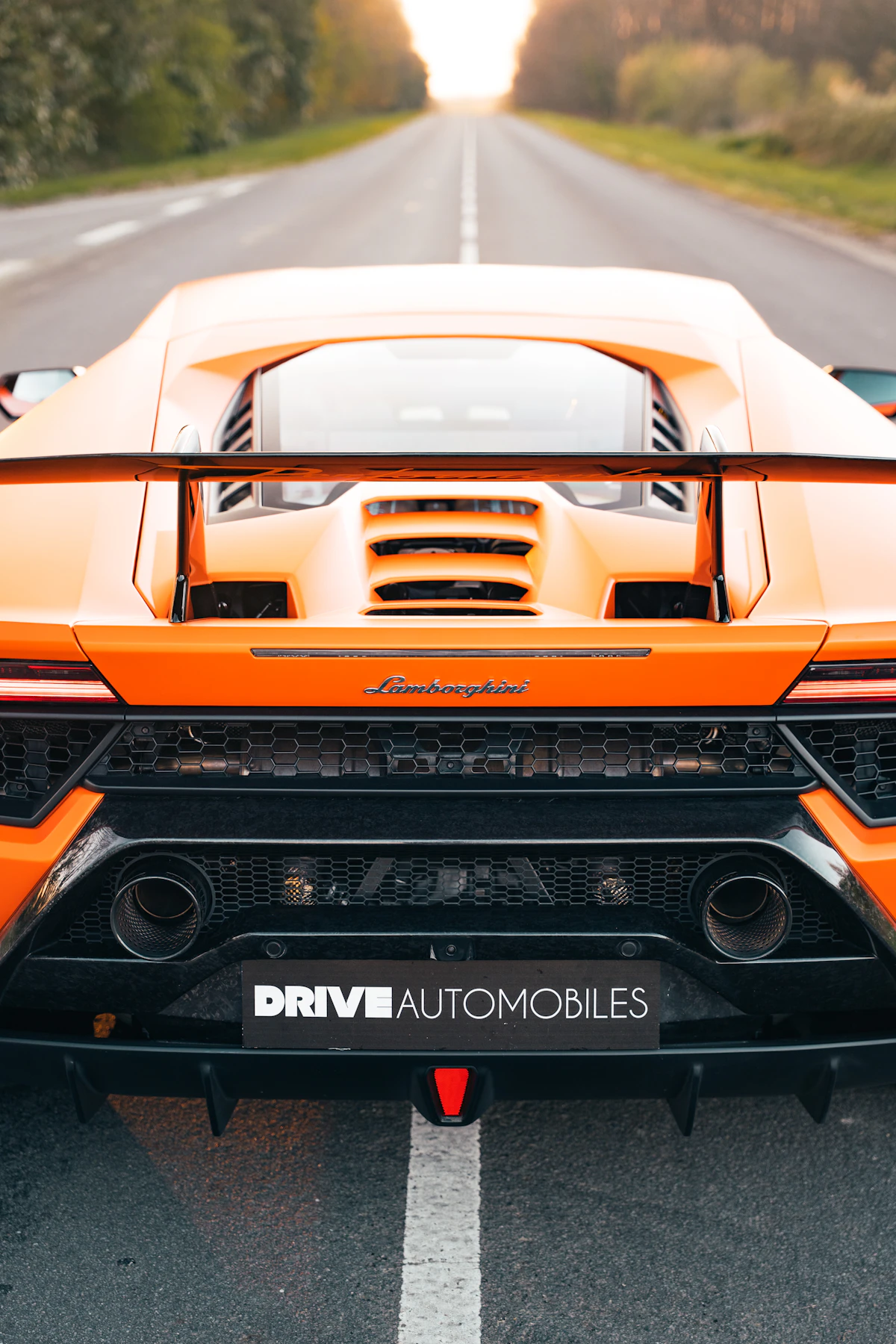Sports car on an open road toward the horizon