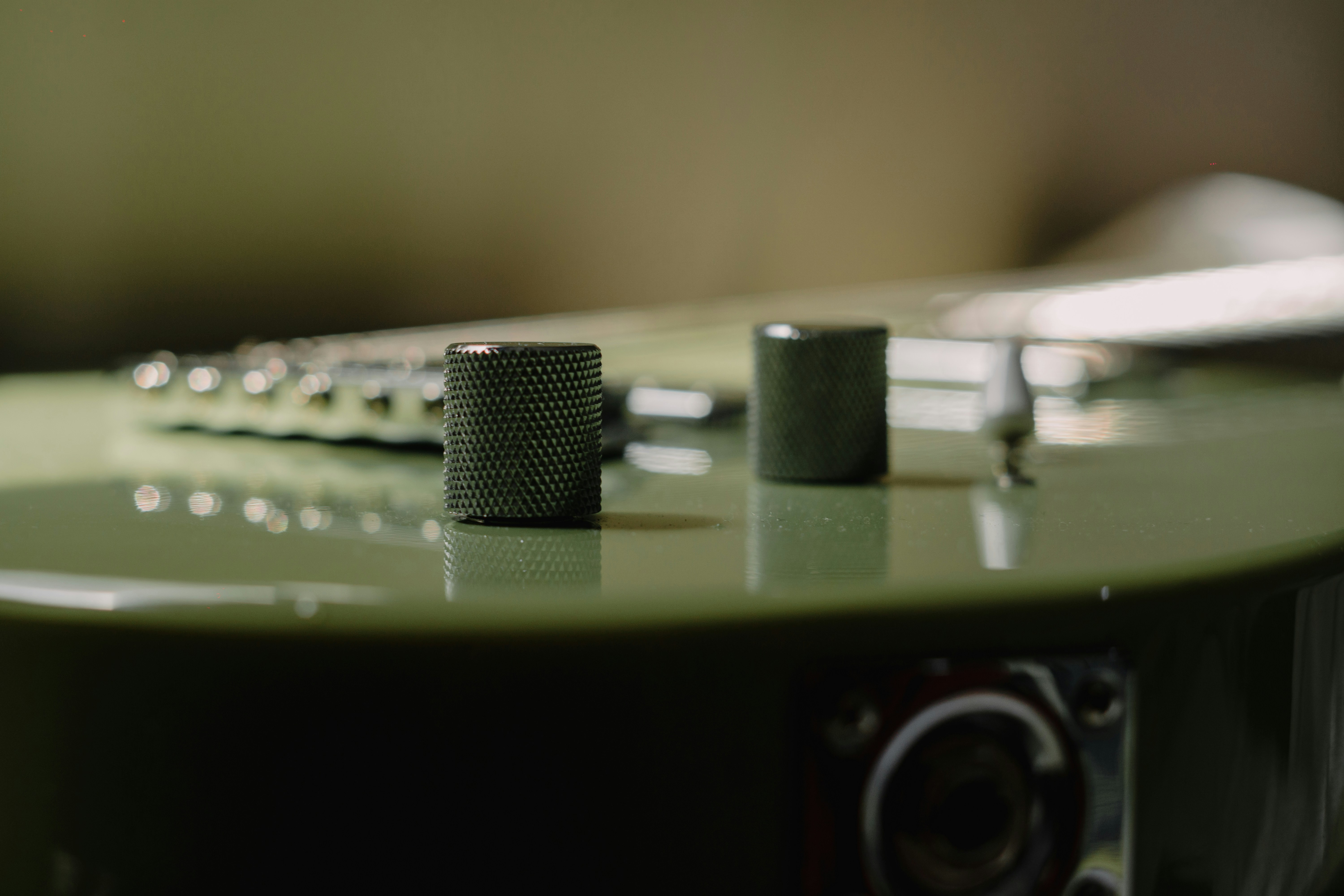 Electric guitar with control knobs and bridge.