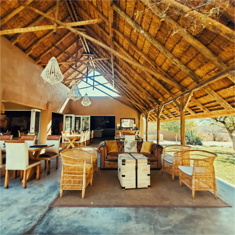 Thatched-roof guesthouse lounge, the kind of hospitality business the booking-site concept was designed for