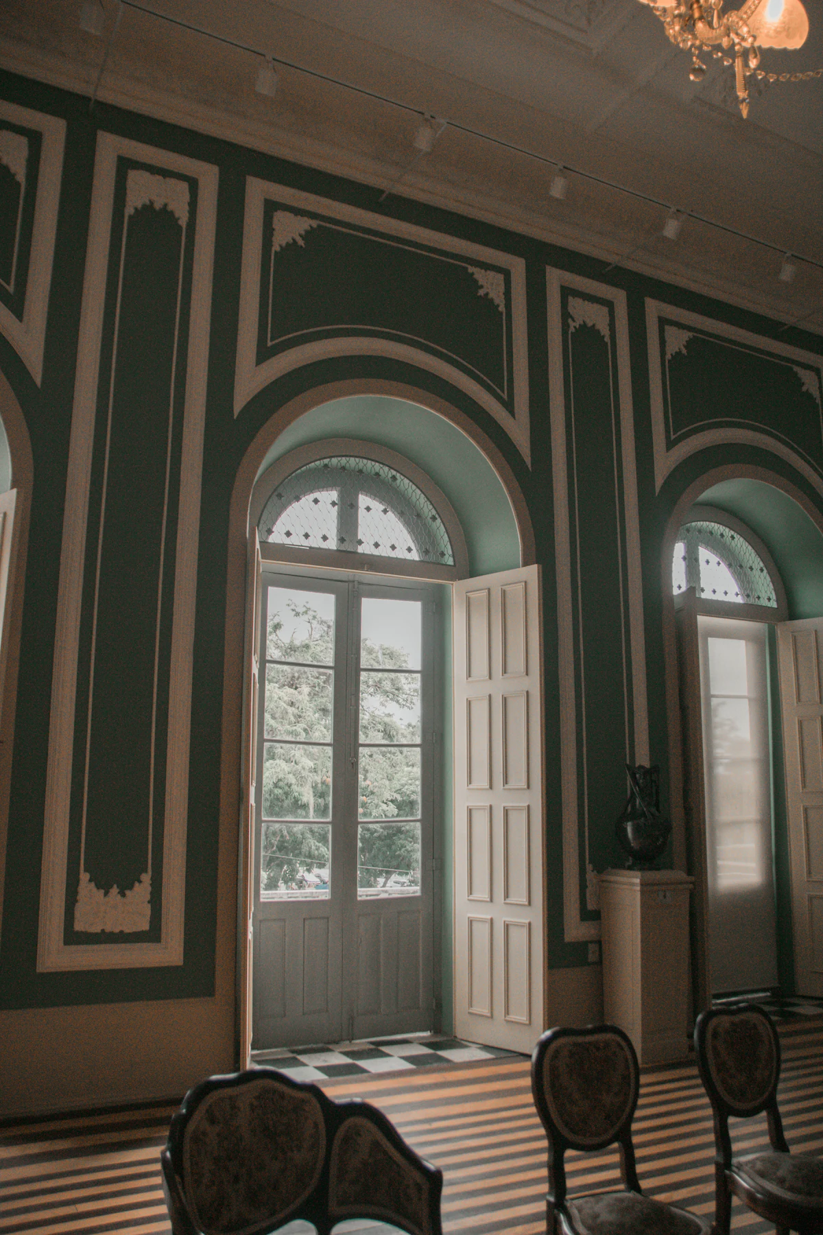 Arched windows in a panelled room. Illustrative editorial image, not a photograph of Ebenezer Hancock House.