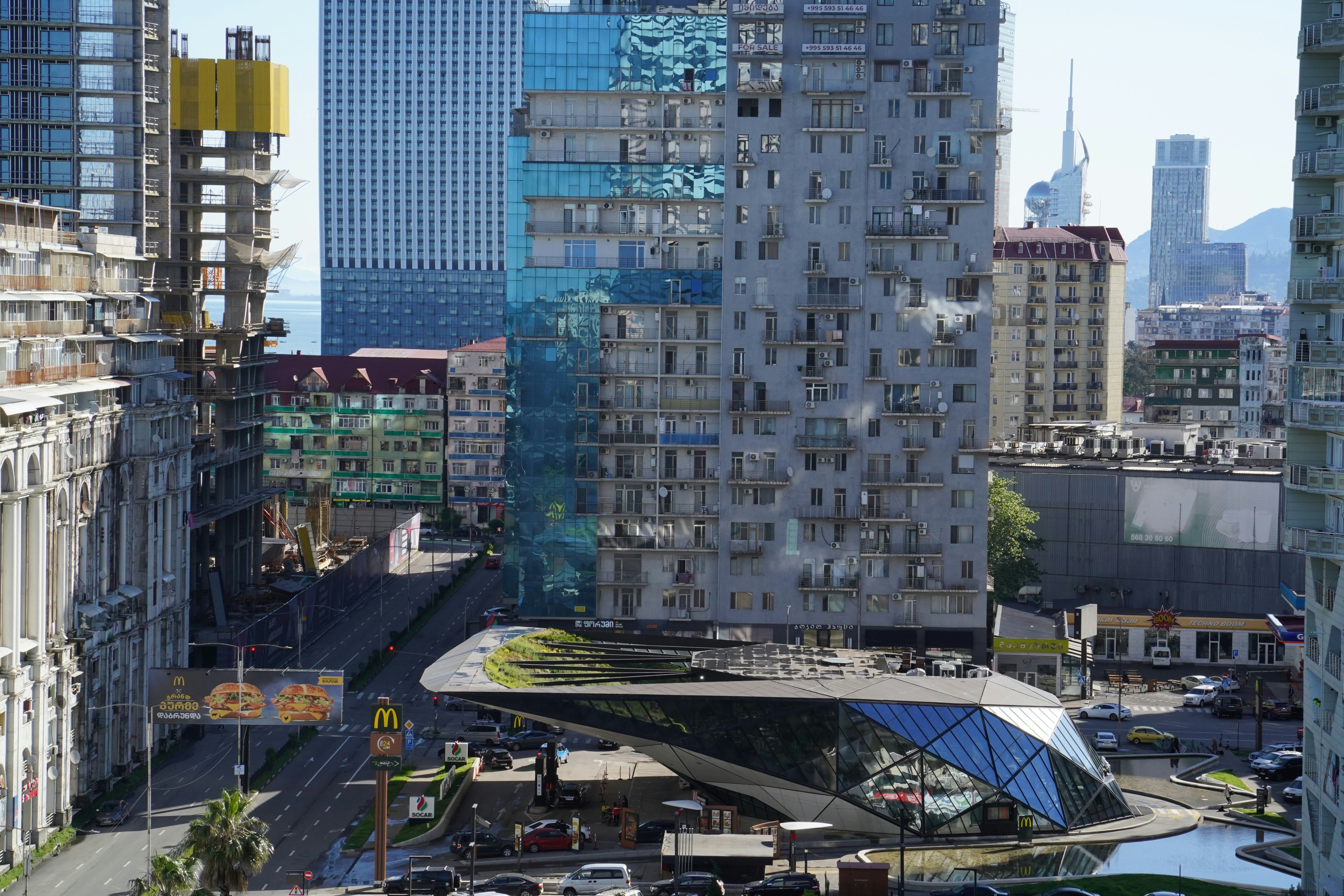 Cityscape with diverse buildings and a distinctive modern structure.