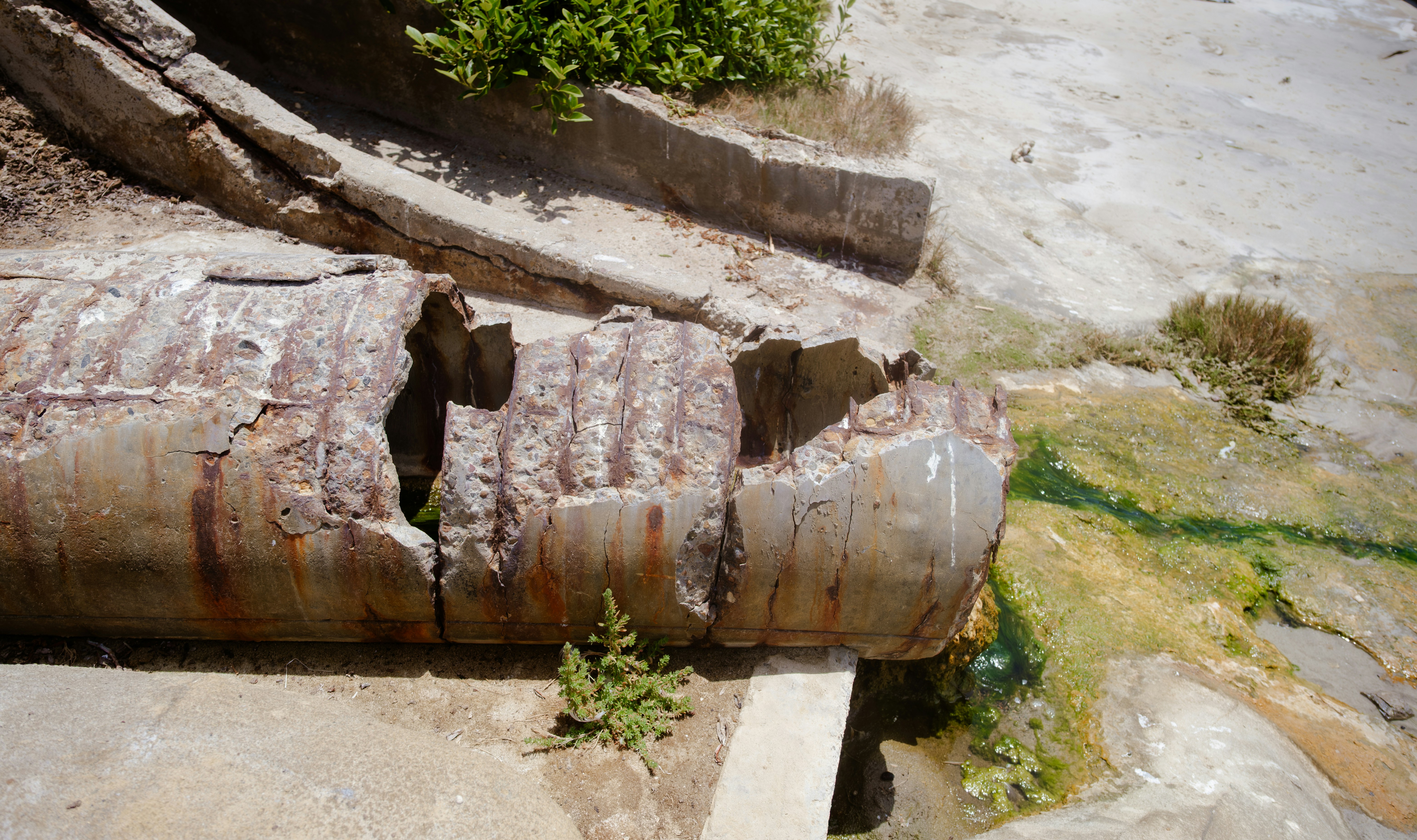 Corroded galvanized water pipe showing severe rust and scale buildup