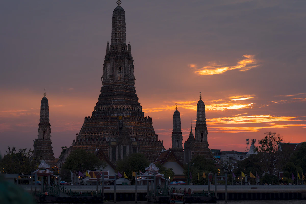 Bangkok's illuminated temples and riverfront skyline after dark