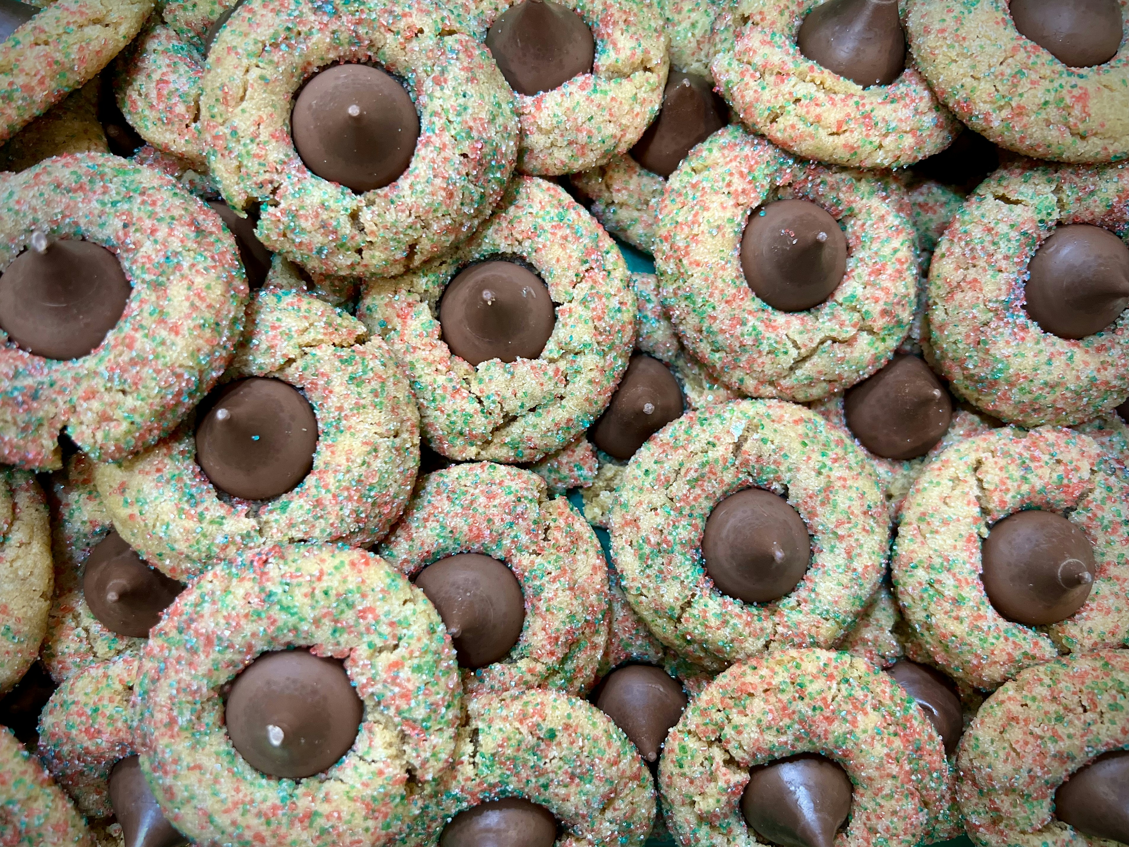Molti biscotti colorati spolverizzano con baci al cioccolato.