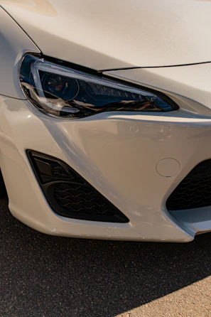 White car's front headlight and bumper