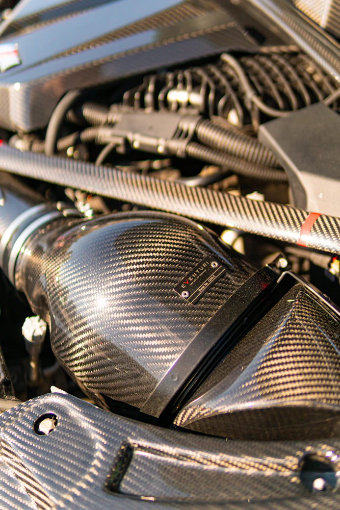 High-performance car engine with a carbon fiber air intake.
