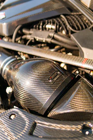 High-performance car engine with a carbon fiber air intake.
