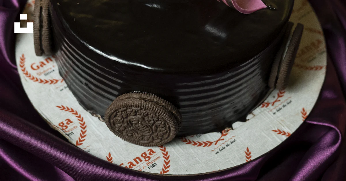 A decadent chocolate cake adorned with oreo cookies and ribbons. photo ...