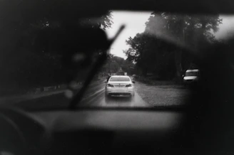 Rainy drive from inside a car on a wet road.