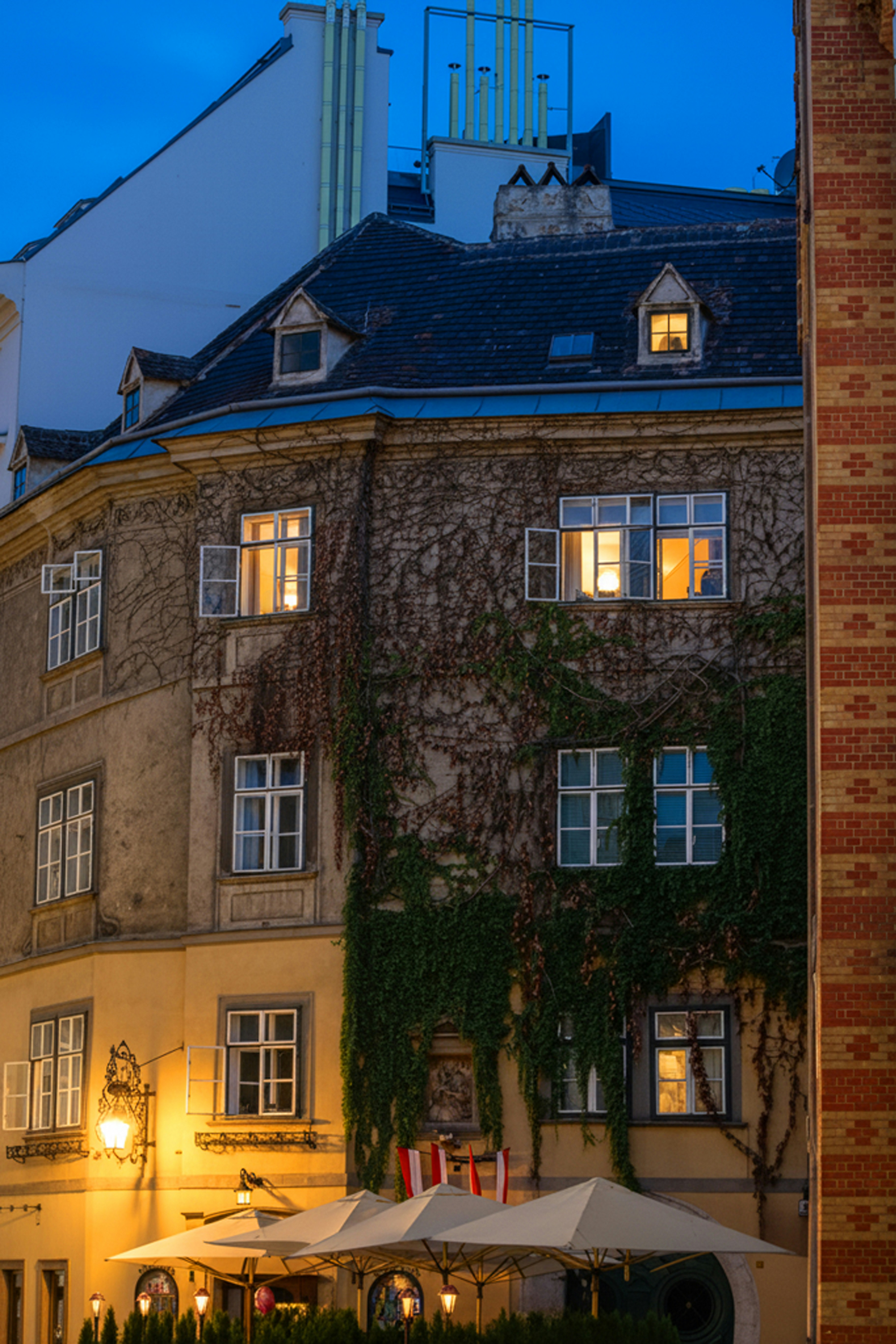 Vienna old-town street at evening with historic facades and lamplight