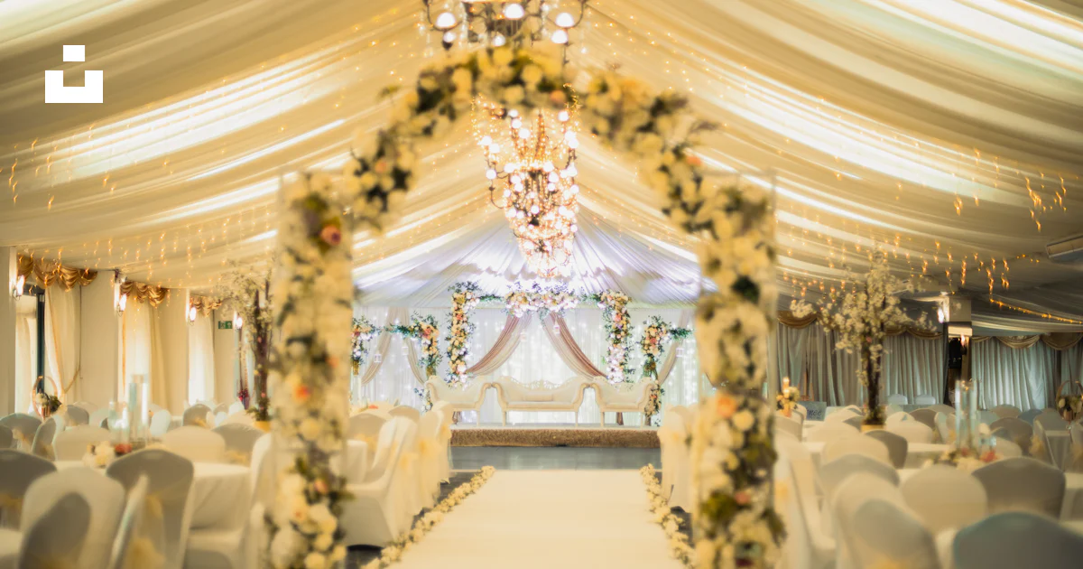 Elegant wedding reception hall with floral archway and white decor ...