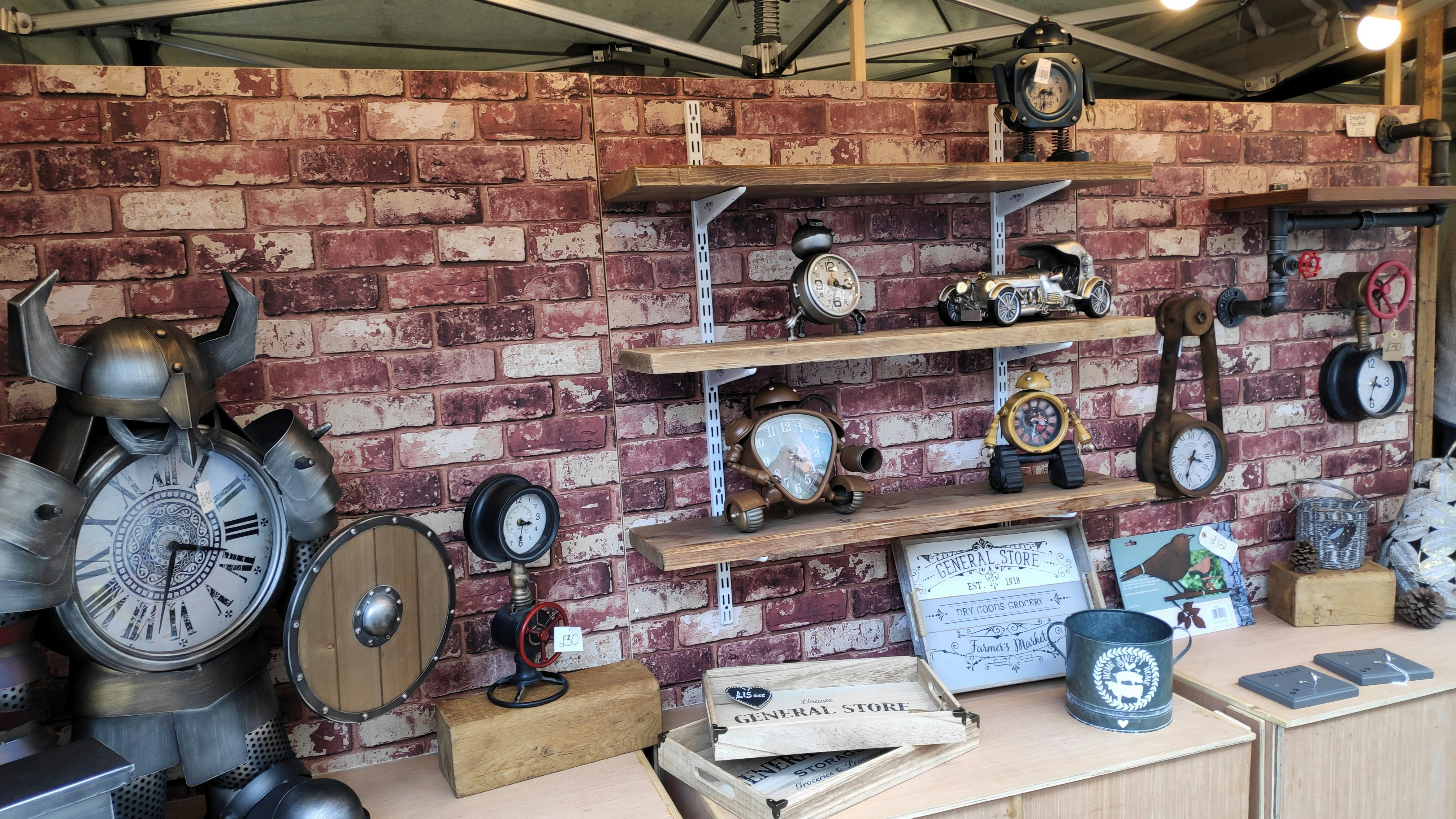 Antique clocks and decor displayed on wooden shelves.