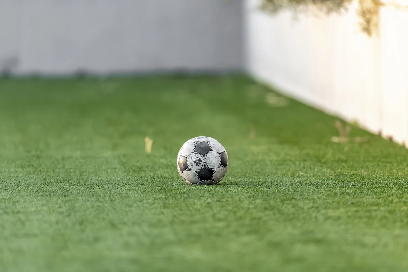 A worn football on artificial turf