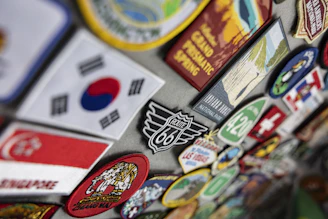 Colorful travel patches and magnets featuring flags and destinations.