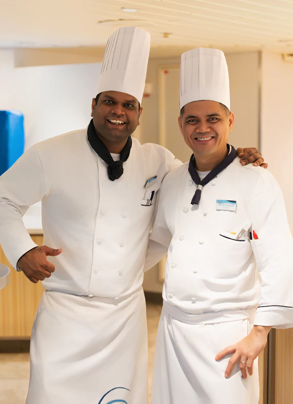 Two chefs in white kitchen uniforms
