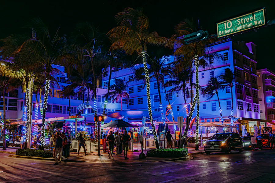 Neon-lit buildings and palm trees at night