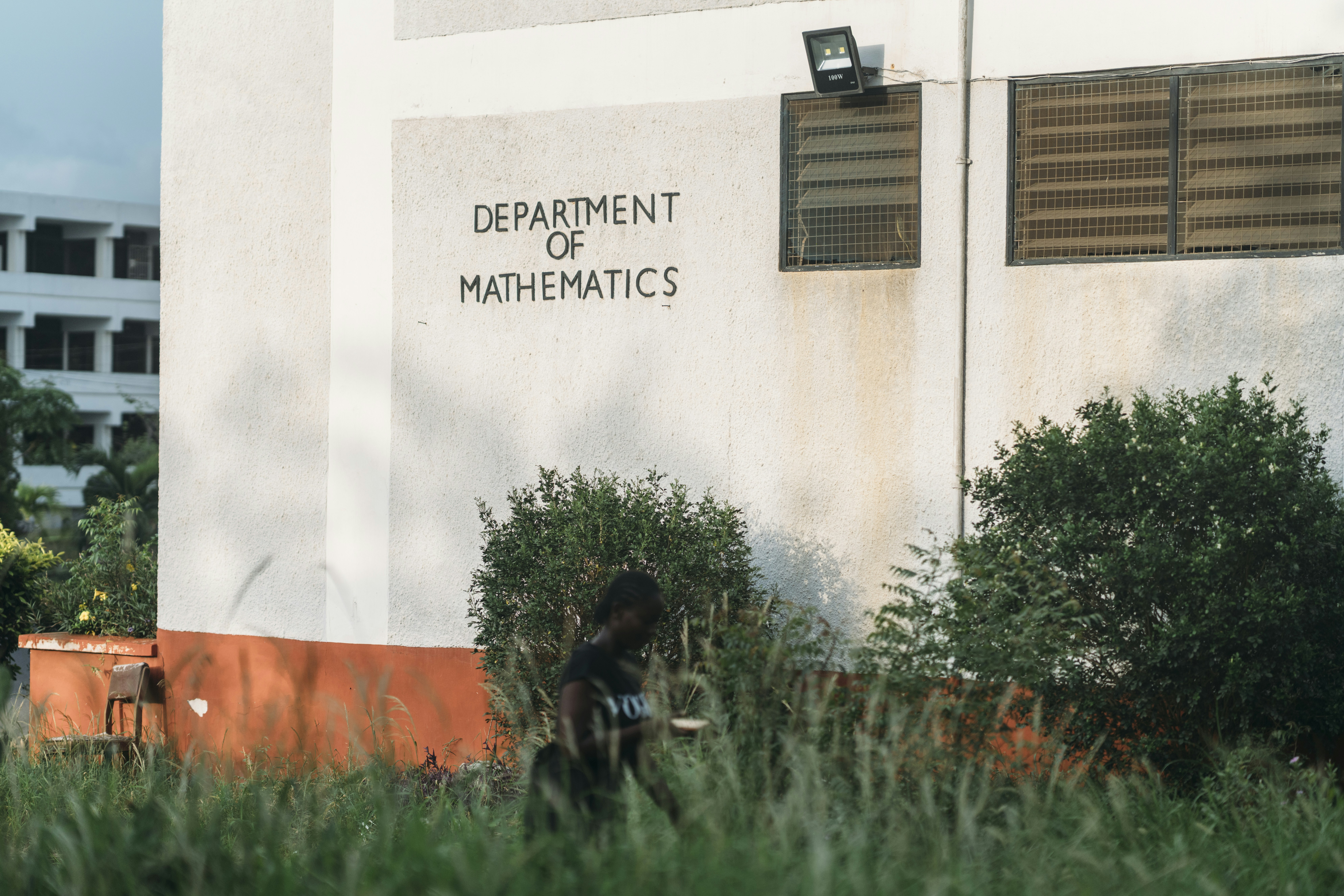 A person walks past the department of mathematics building.