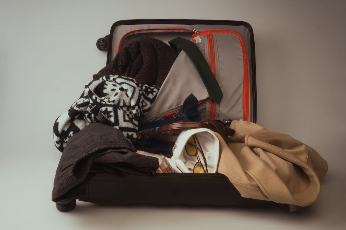 An open suitcase overflowing with clothes — the overpacking problem