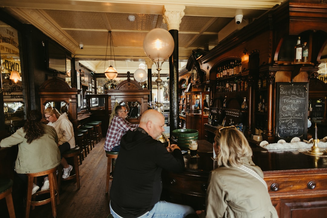 People enjoying drinks in a traditional pub interior.