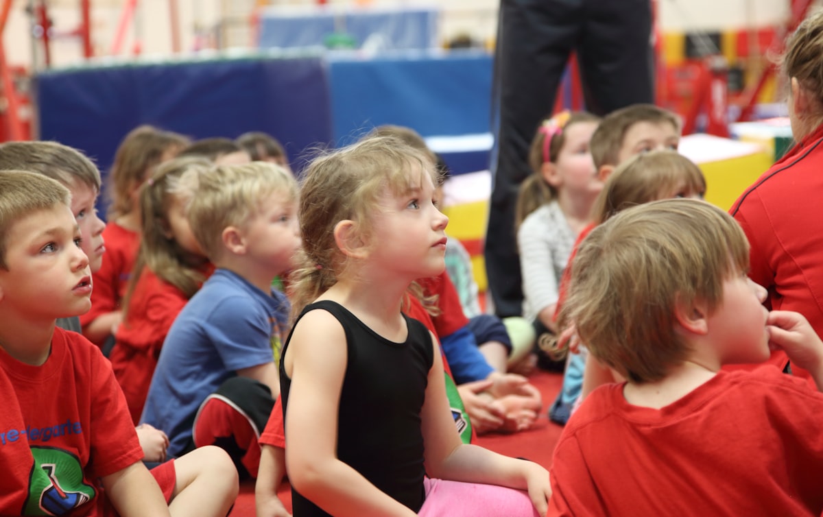 Kindergarten class sitting on the mat while the teacher introduces an AI-planned lesson