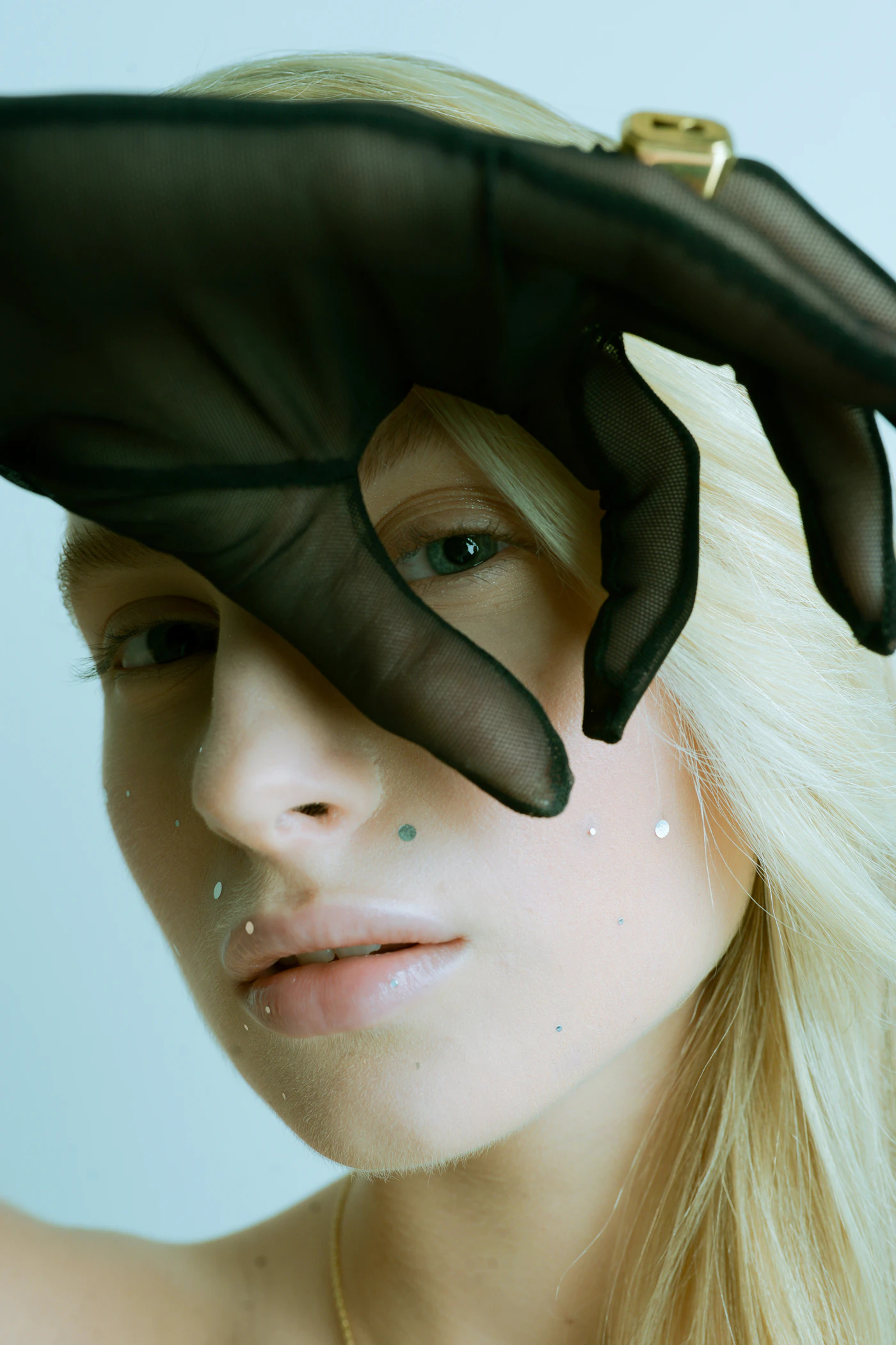 A gloved hand across the face