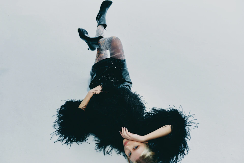 A dramatic black feathered outfit