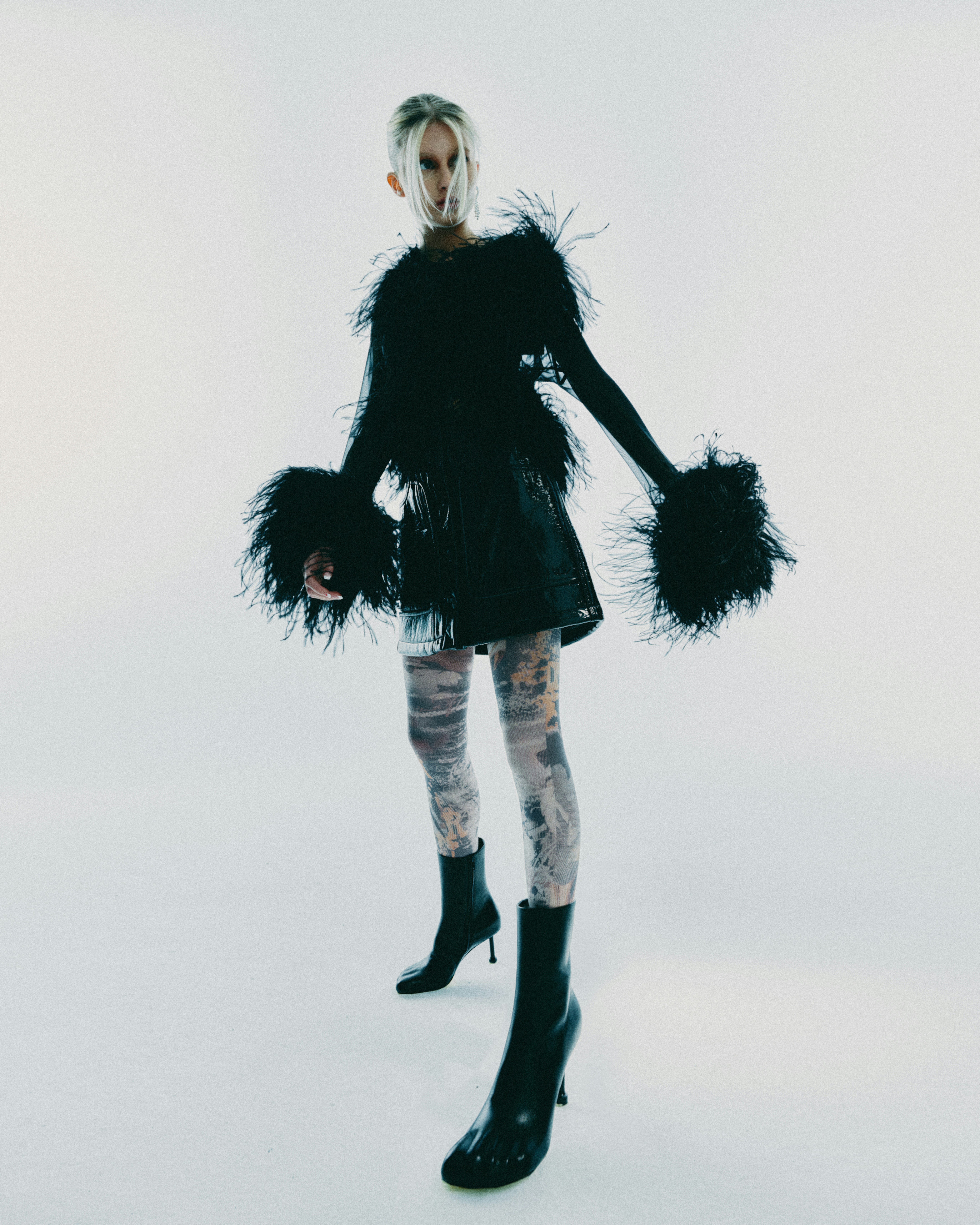 Woman Wearing a Black Feathered Dress and Patterned