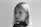 Blonde woman with earrings looking directly at viewer.