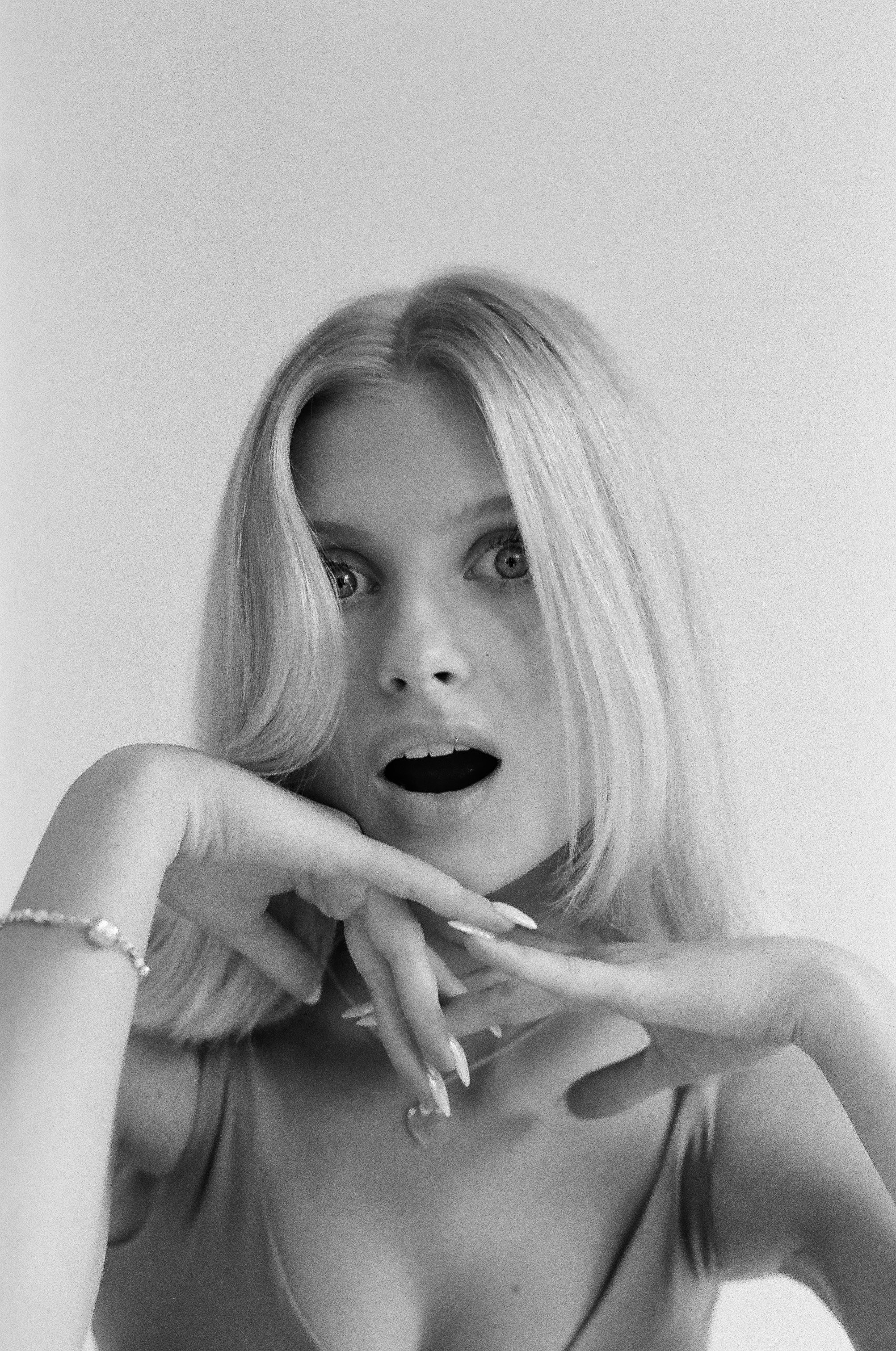 Blonde woman with wide eyes and open mouth looking surprised