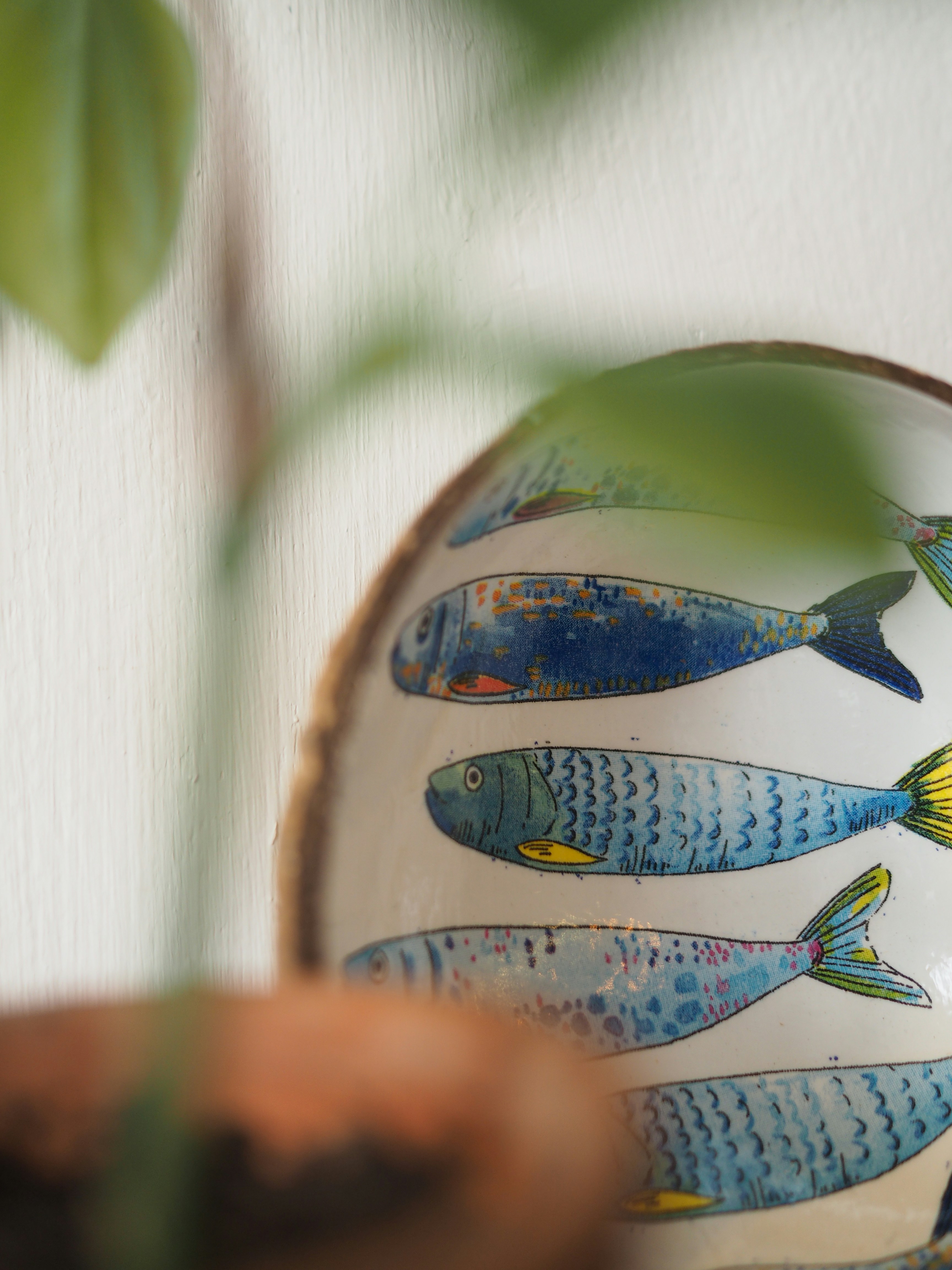 Hand-painted ceramic plate featuring blue fish designs.