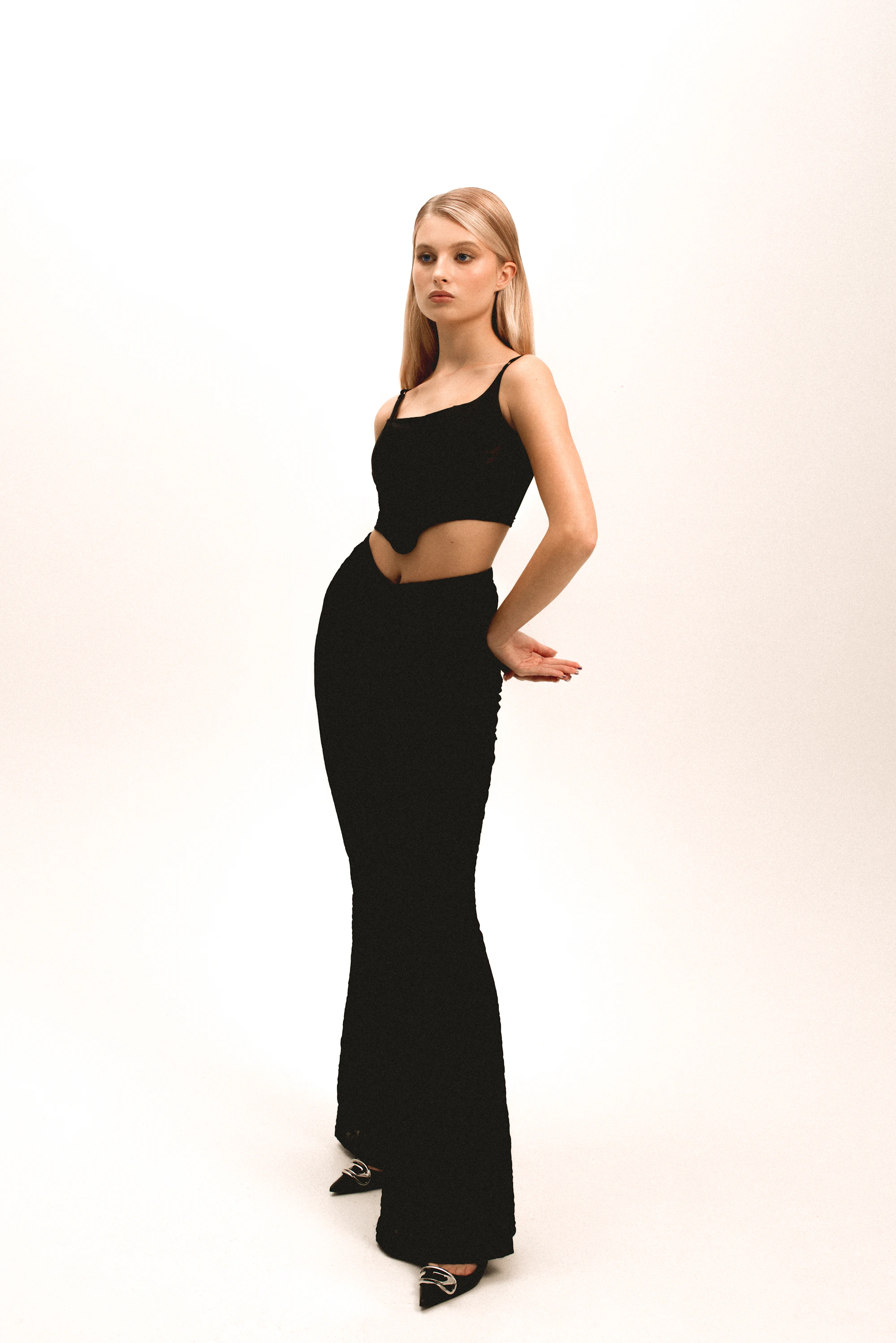 Woman styled in an elegant black editorial look