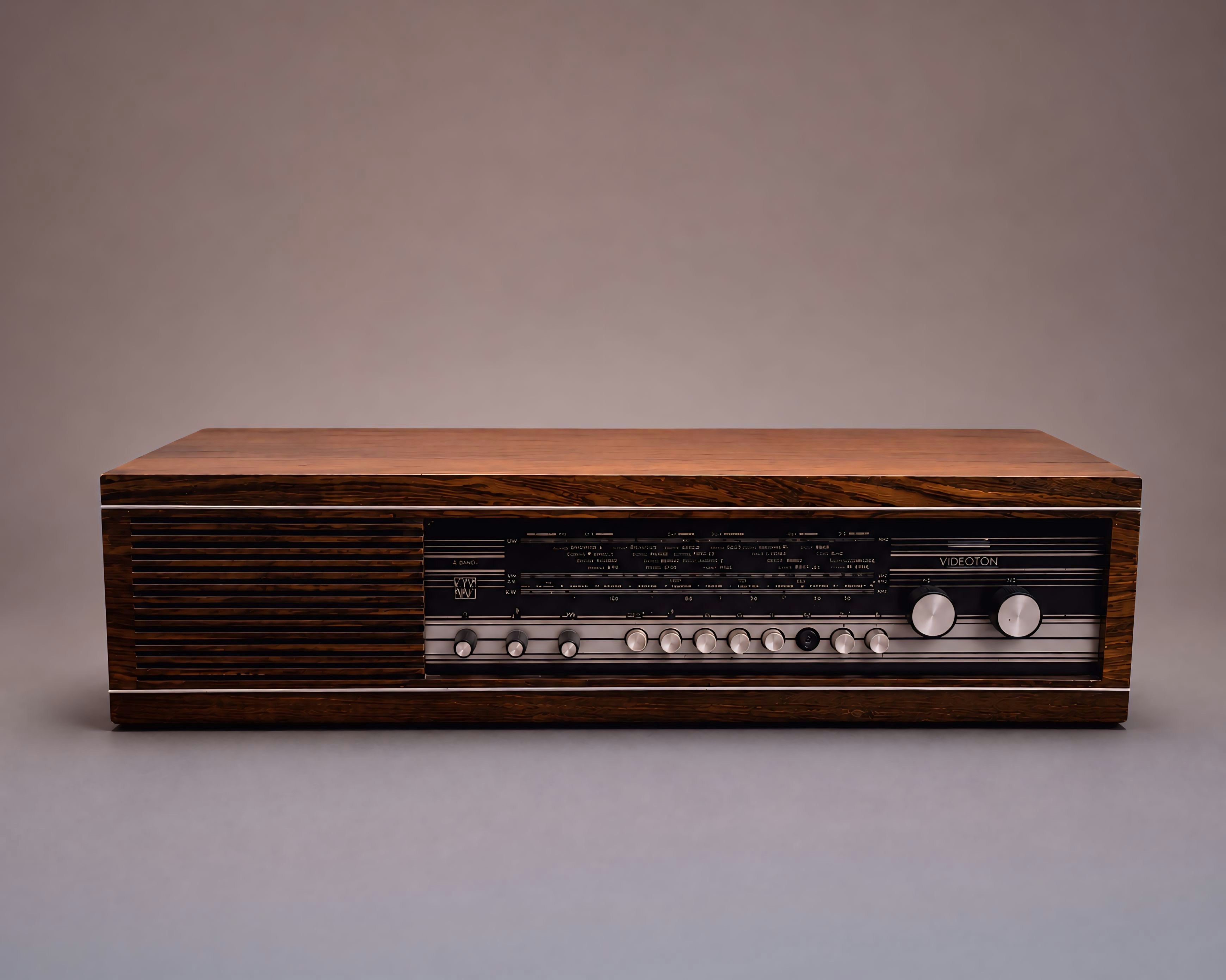 A vintage wooden radio receiver with a silver control panel.