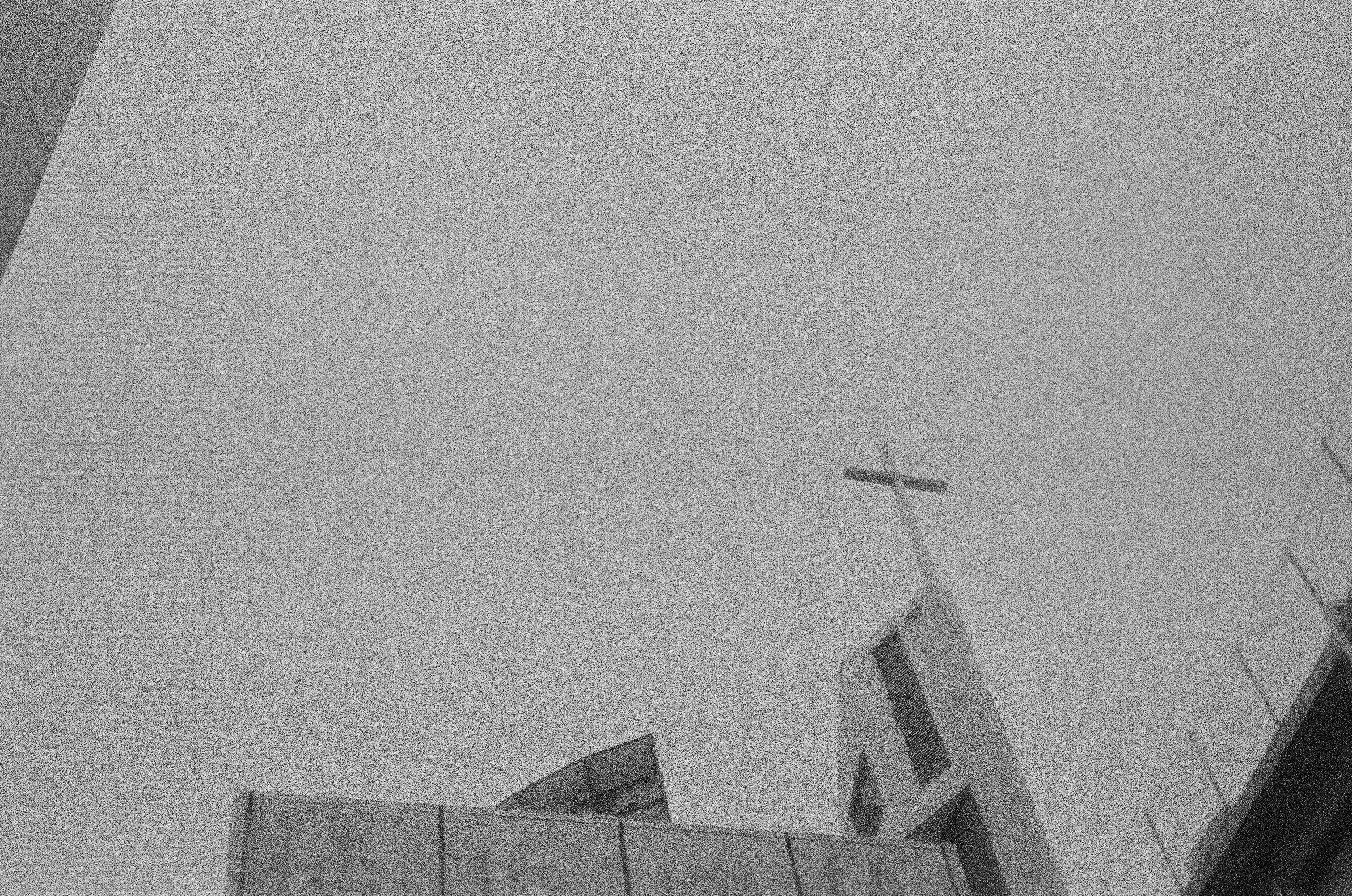Illustrative photo: A church steeple with a cross against a clear sky