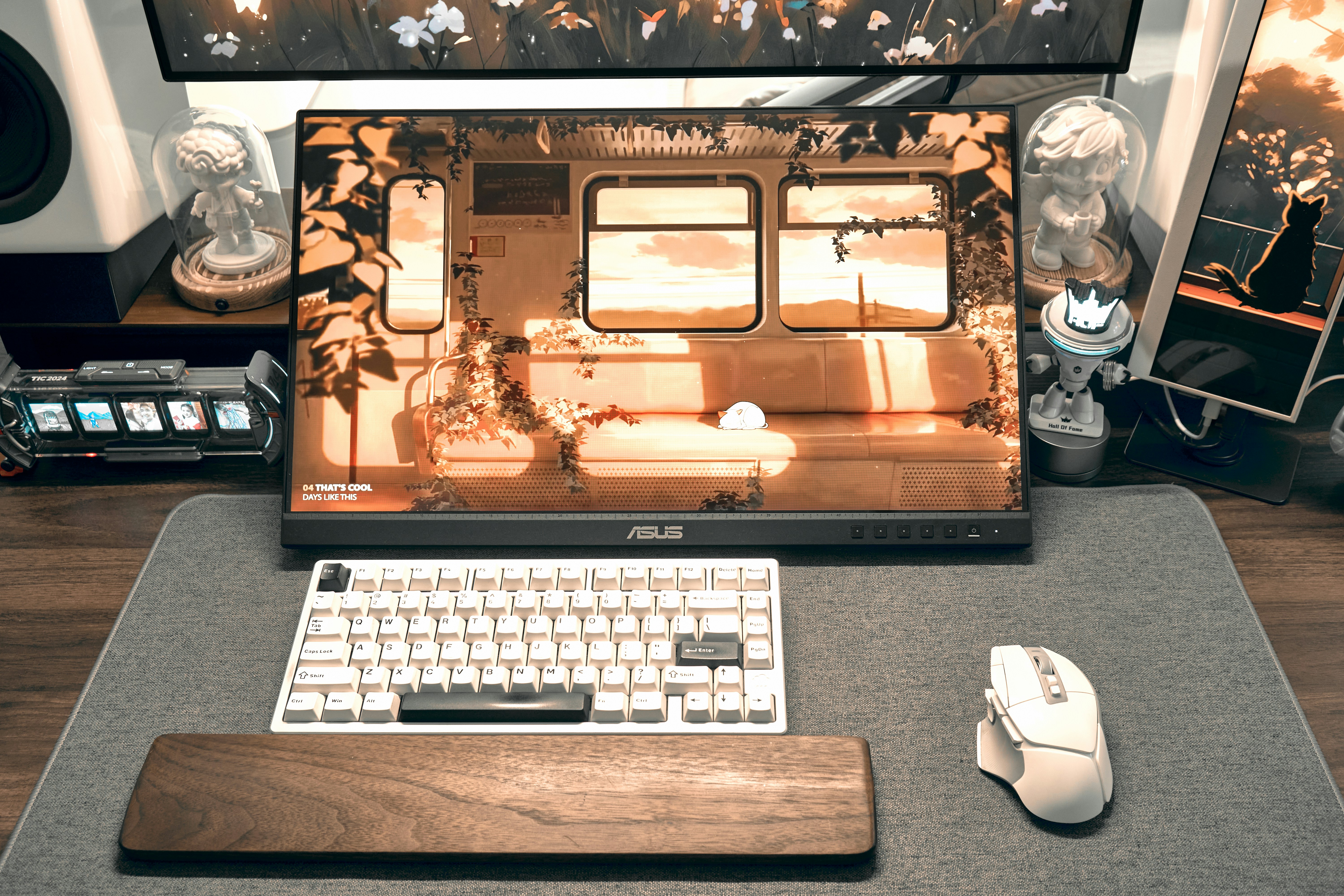 Computer desk with monitor displaying a stylized train interior.
