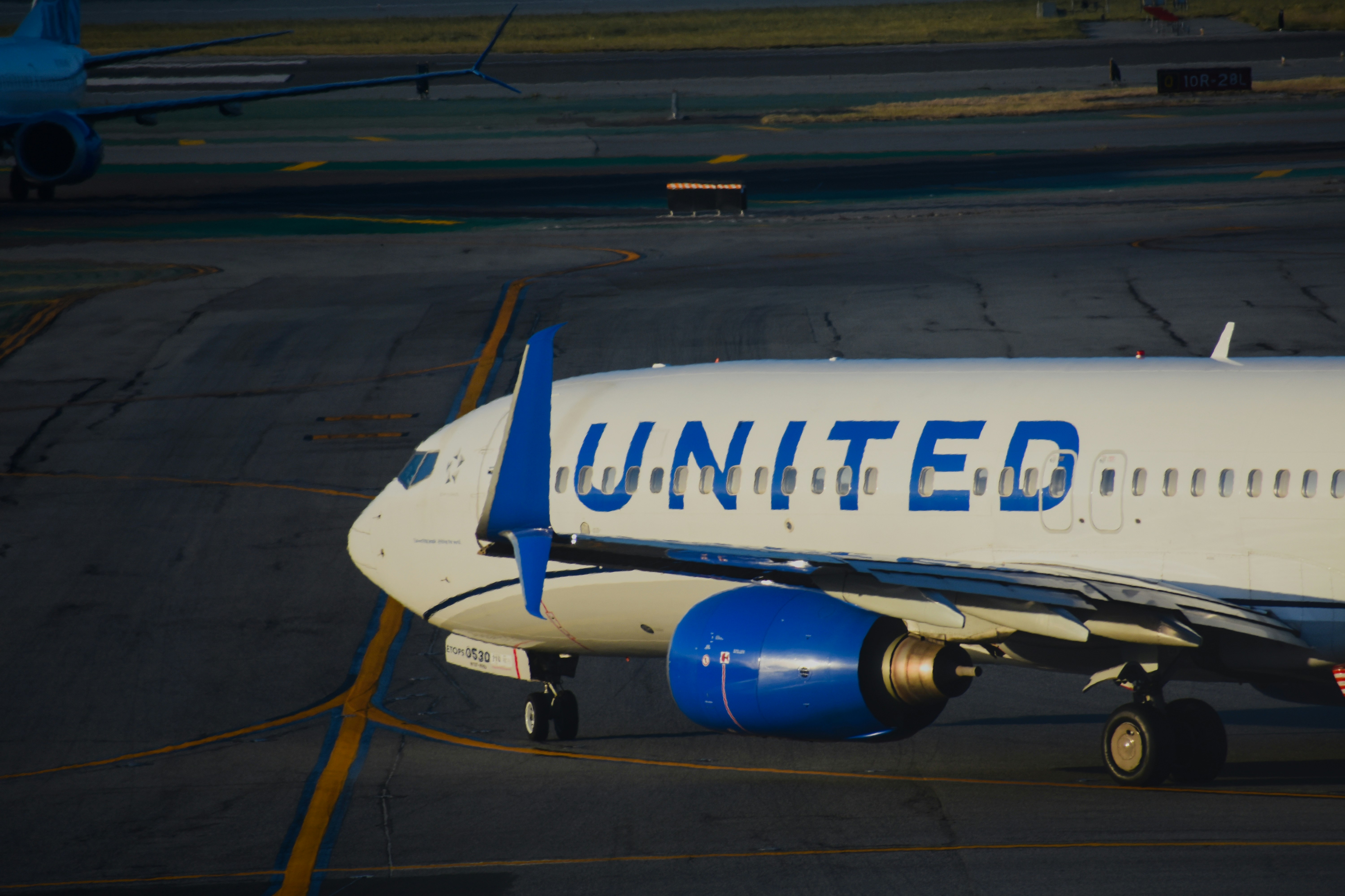 United airlines aircraft parked on an airport tarmac.