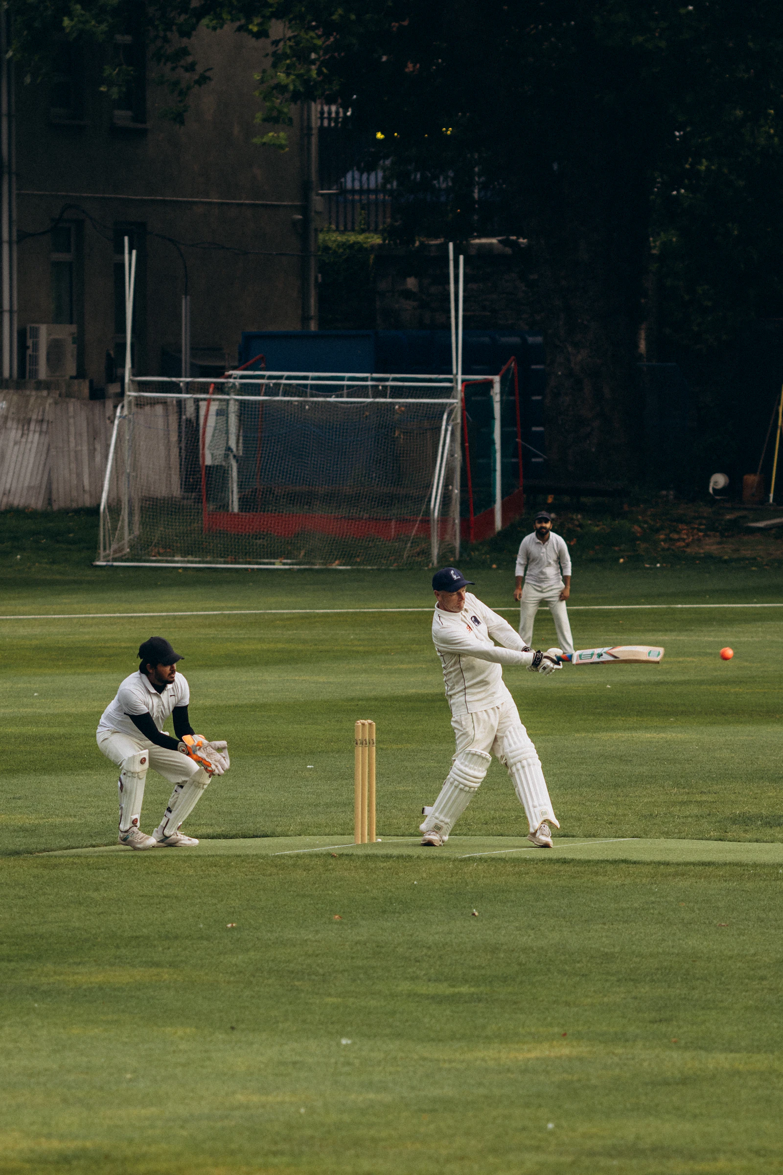 Batsman playing a shot during a cricket match