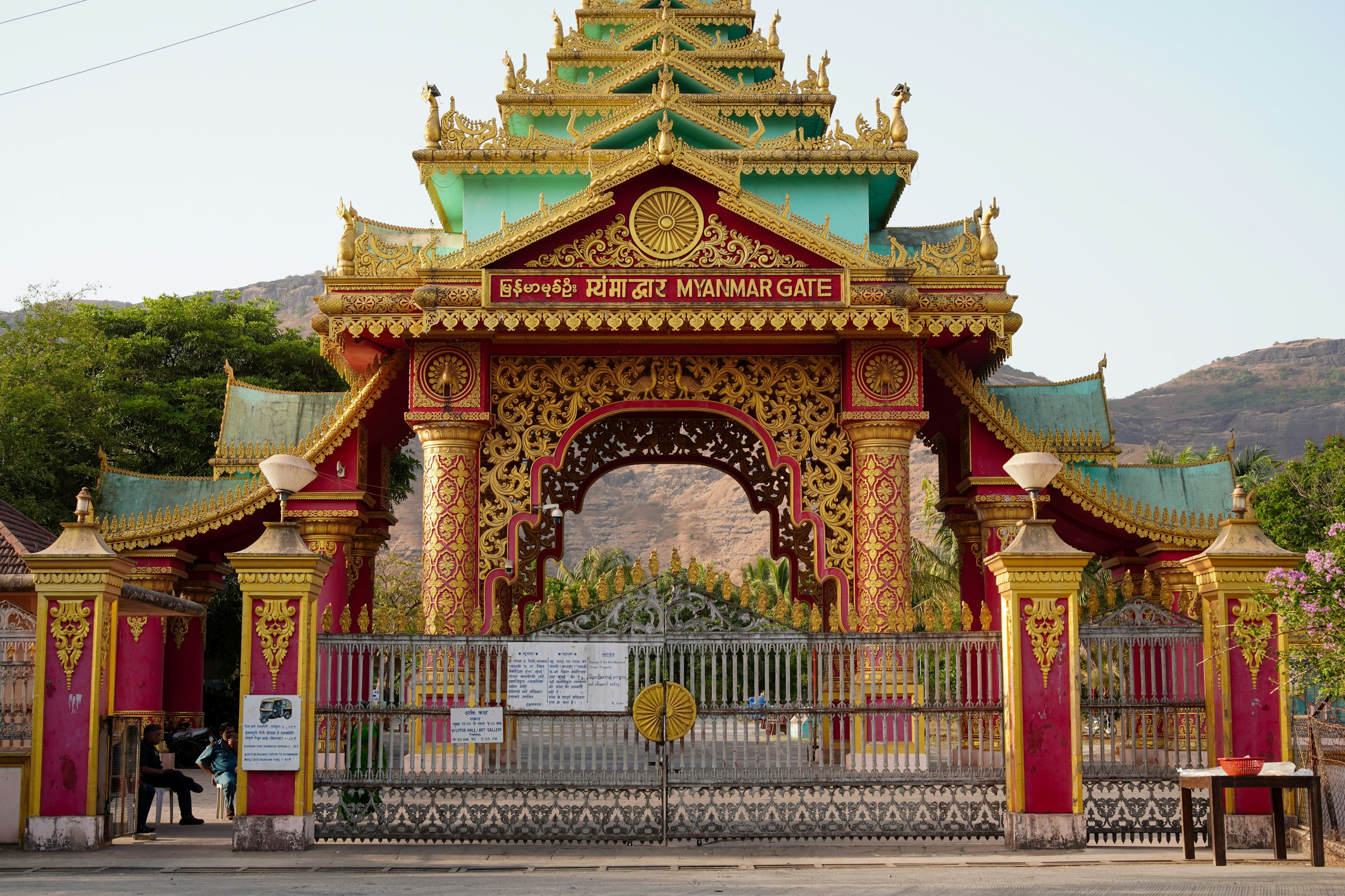 Ornate golden and green temple gate with intricate carvings.