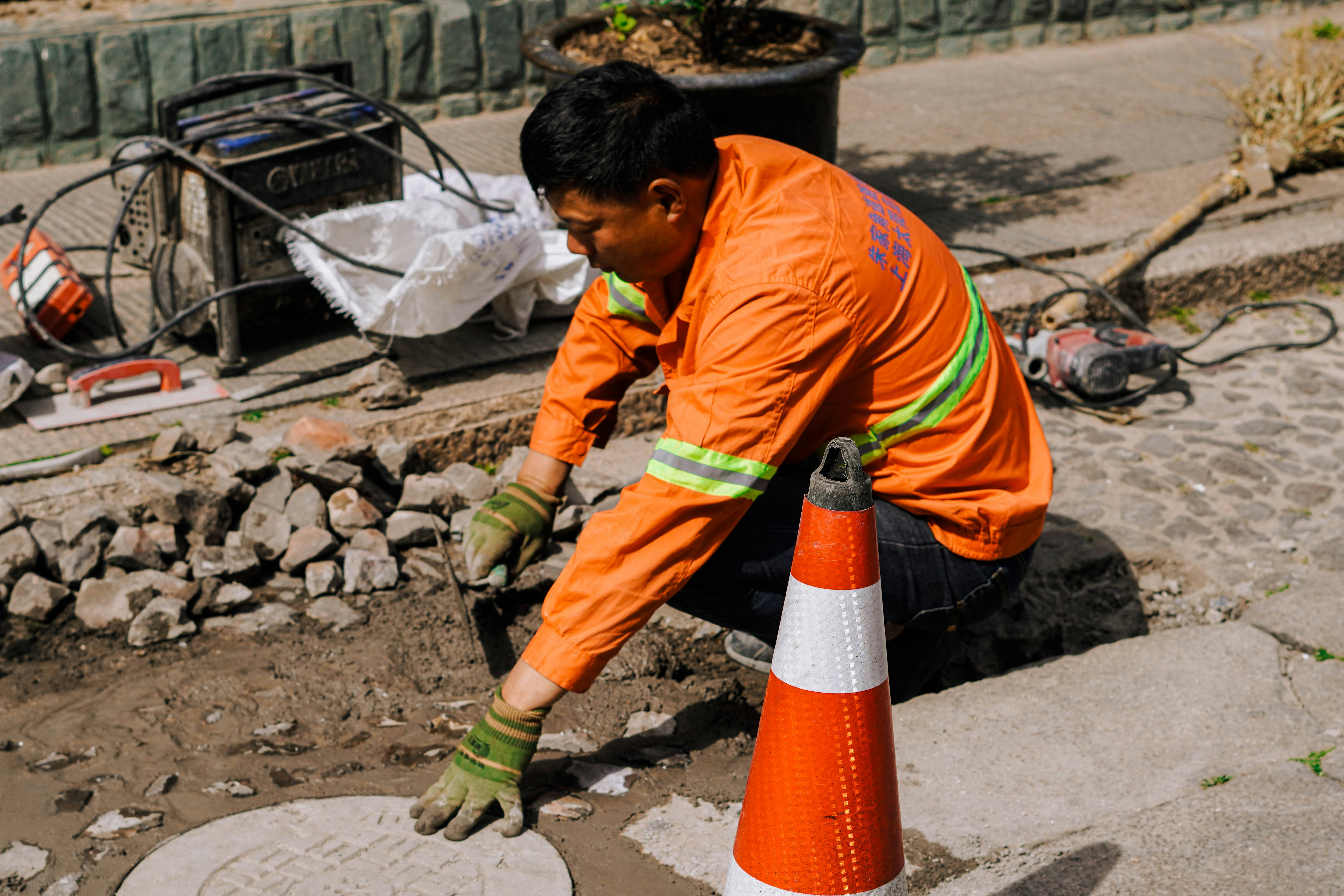certified drainage contractor inspecting a catch basin