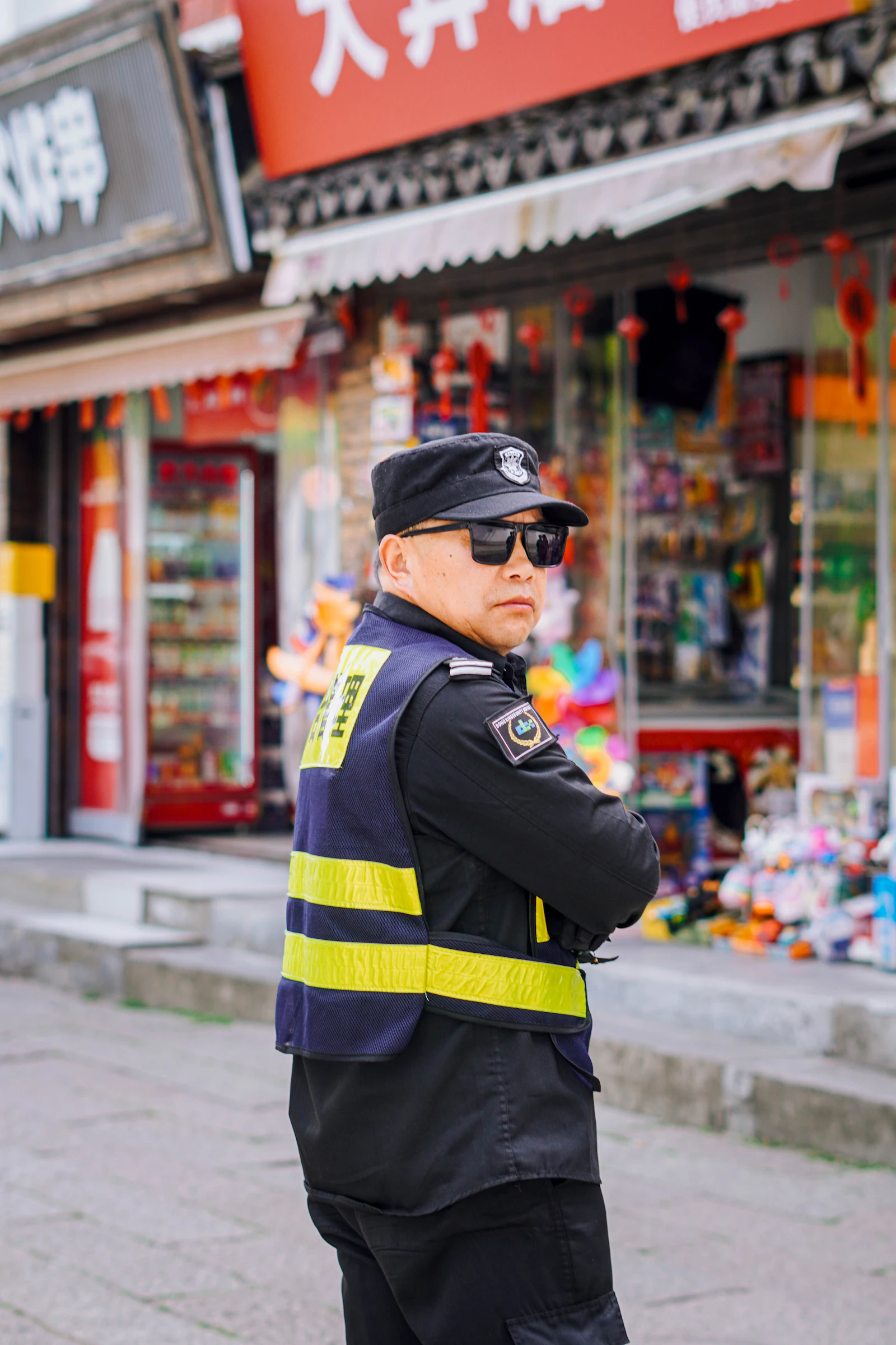 Officer in reflective vest outside a retail row
