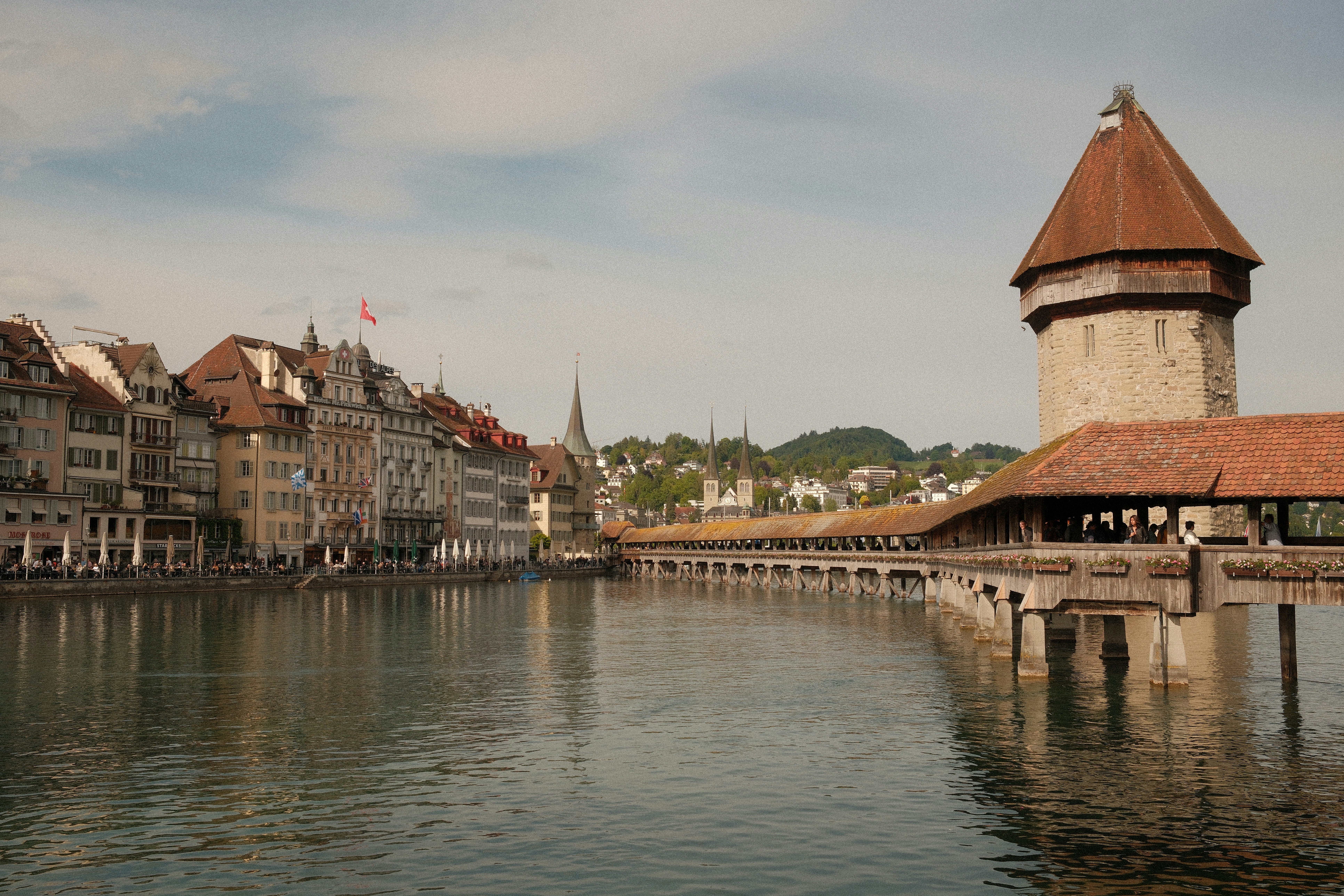 Historic bridge and waterfront buildings line a river.