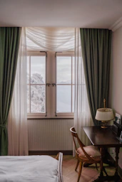 Cozy room with a window view of snowy mountains