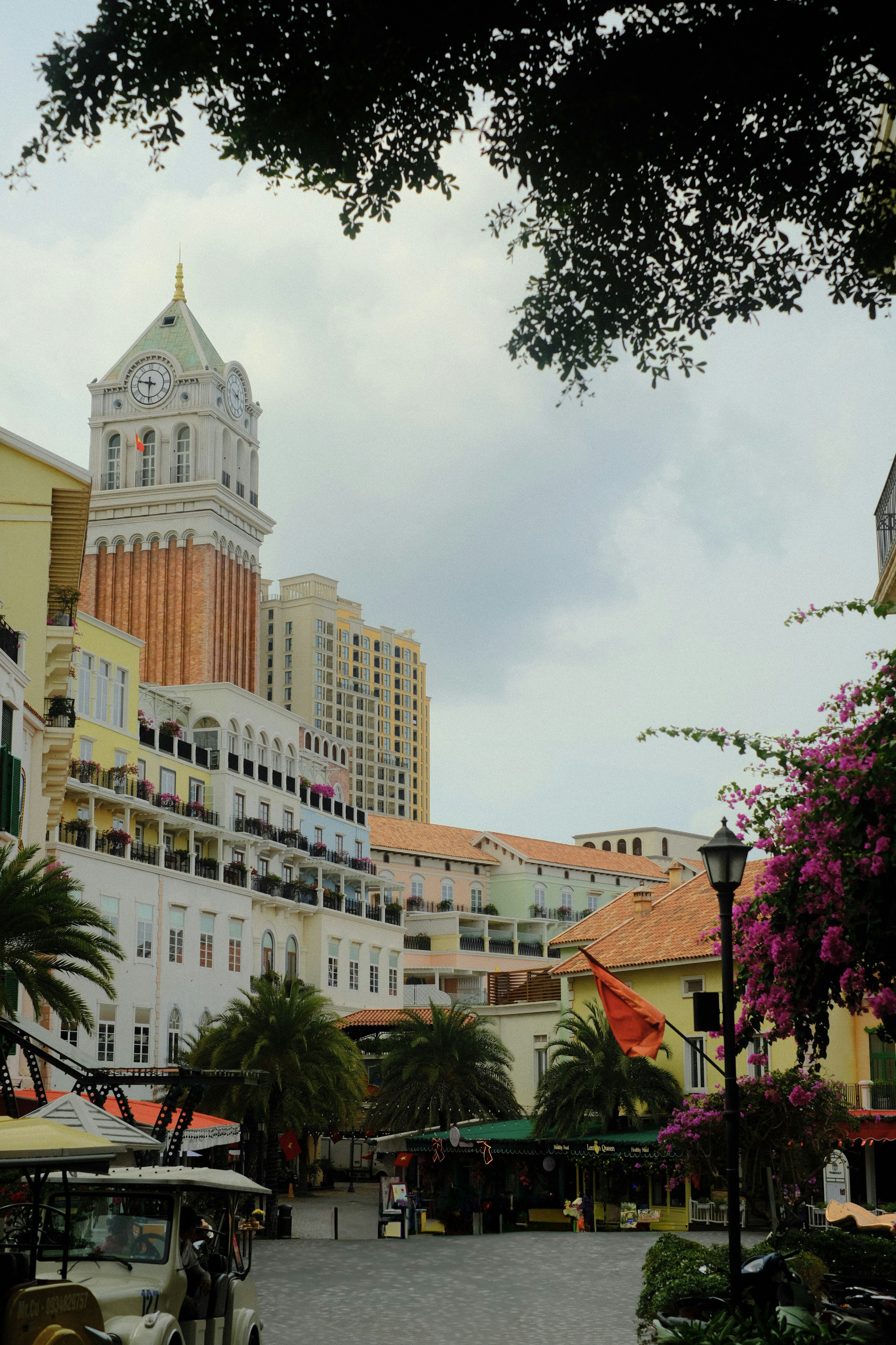 Venetian-style clock tower overlooks a colorful town square.