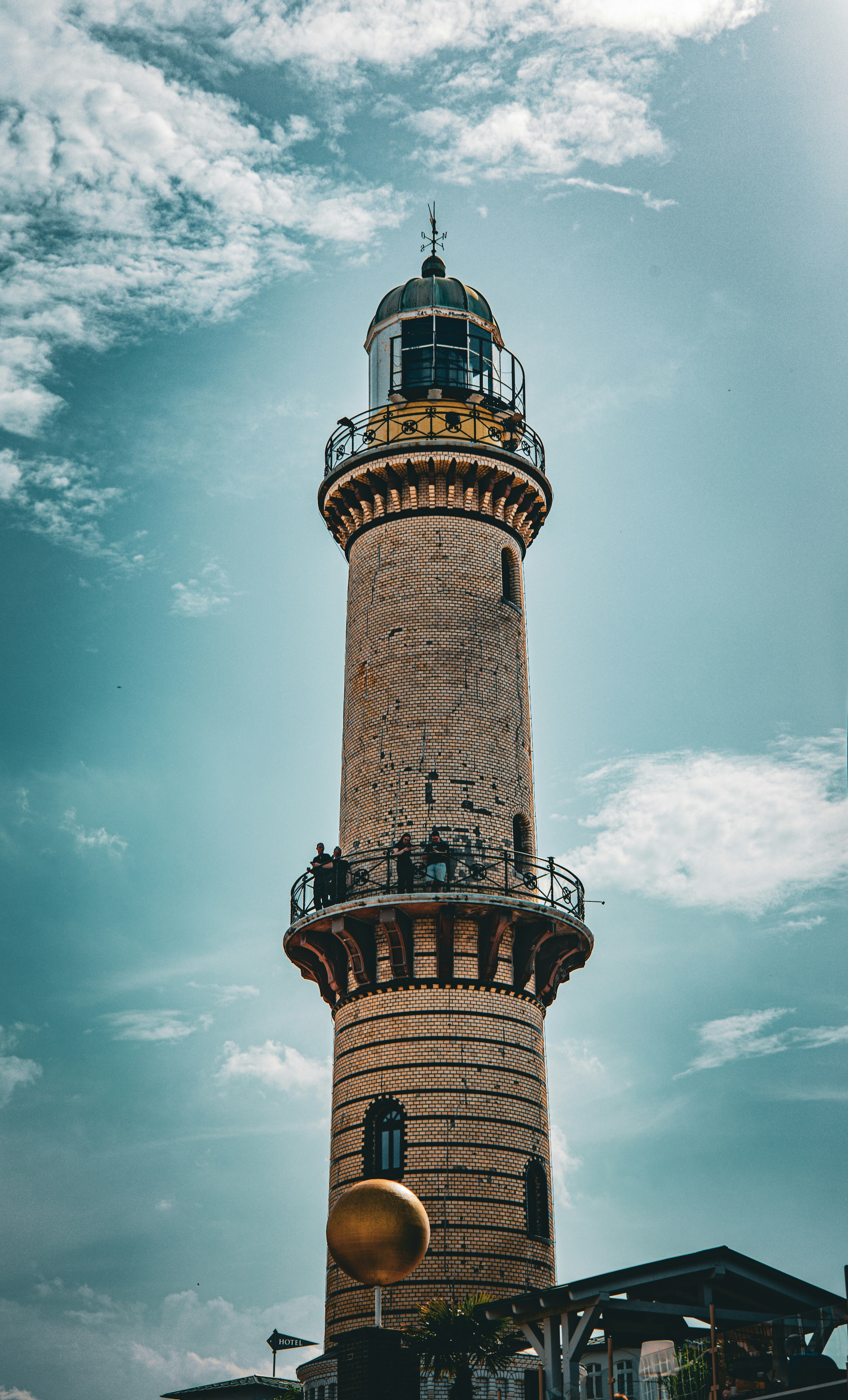 Historic lighthouse with a golden sphere against a blue sky.