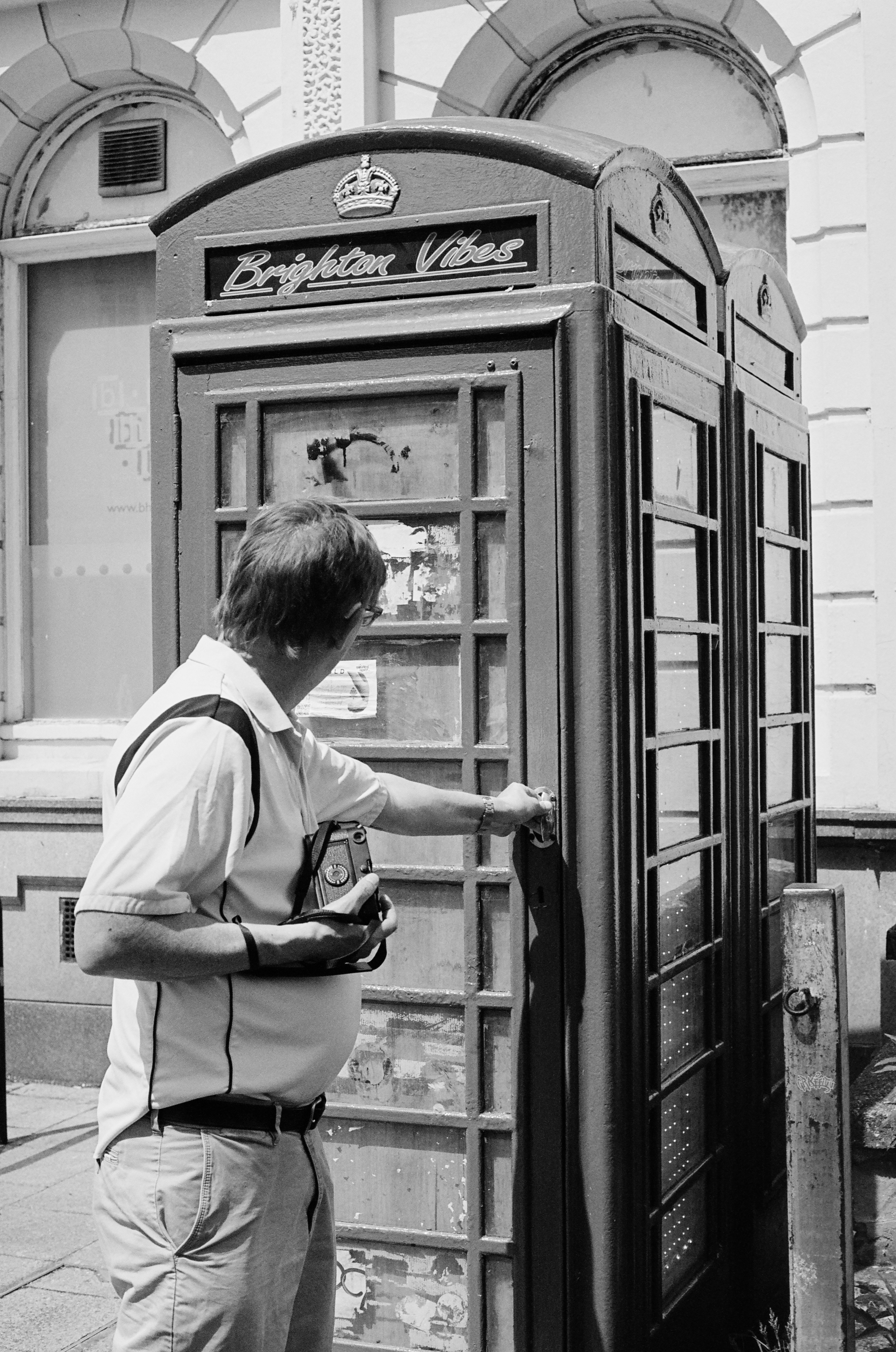 Man interacts with a classic british telephone booth