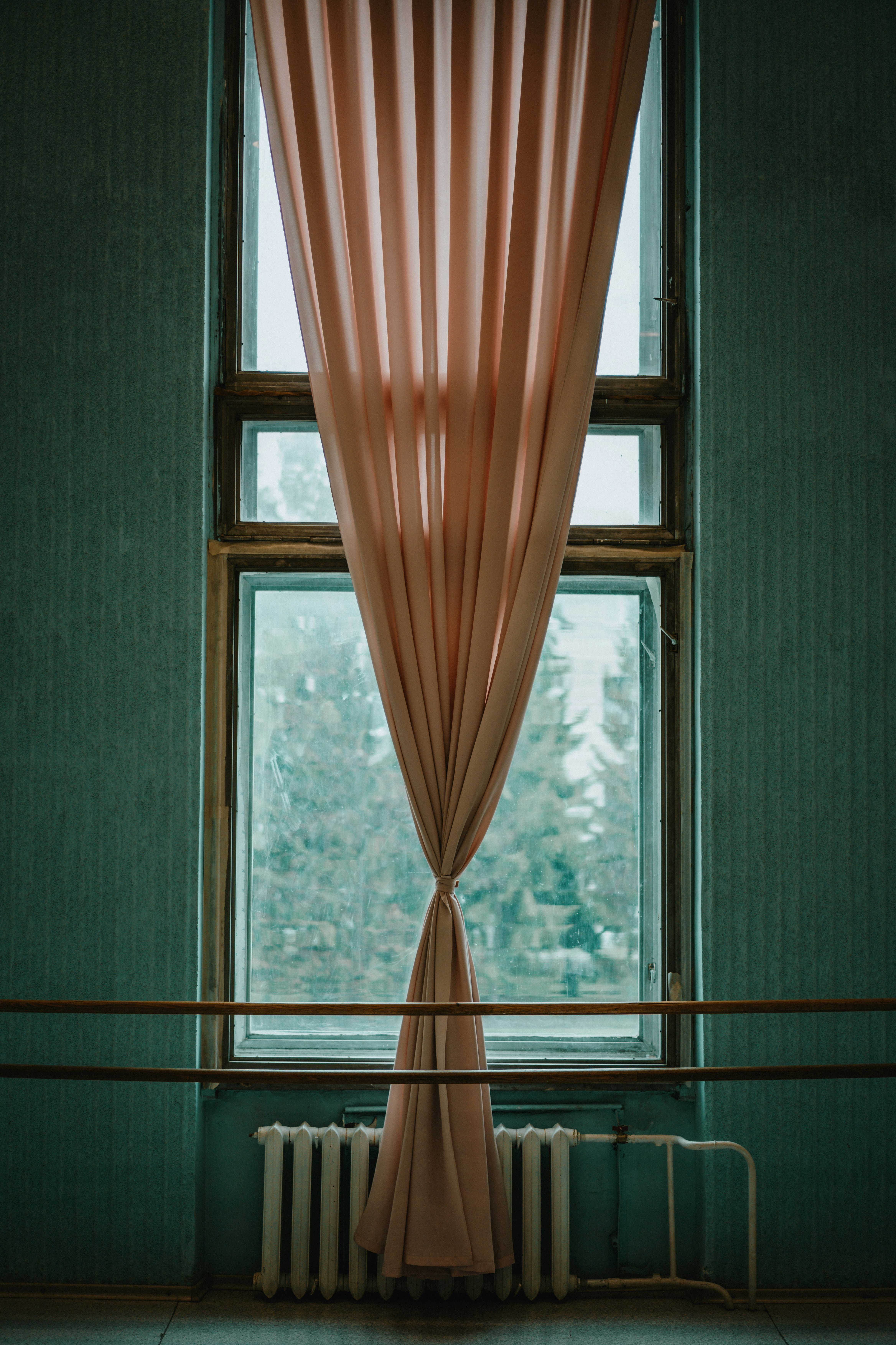 Homeowner measuring winter insulated drapes for better cold weather protection