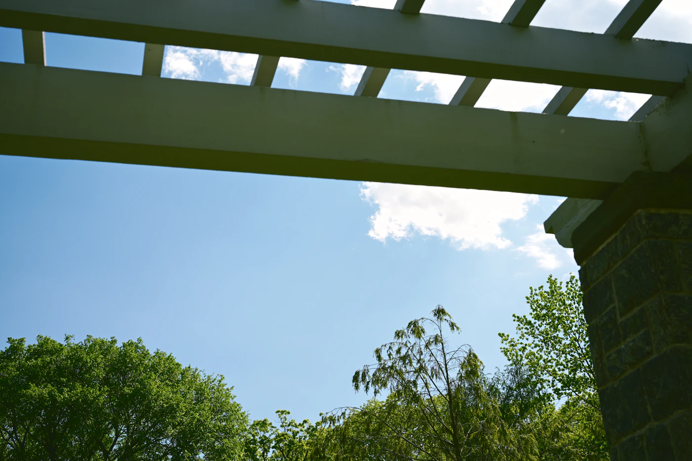 Aluminum pergola providing shade over an outdoor seating area