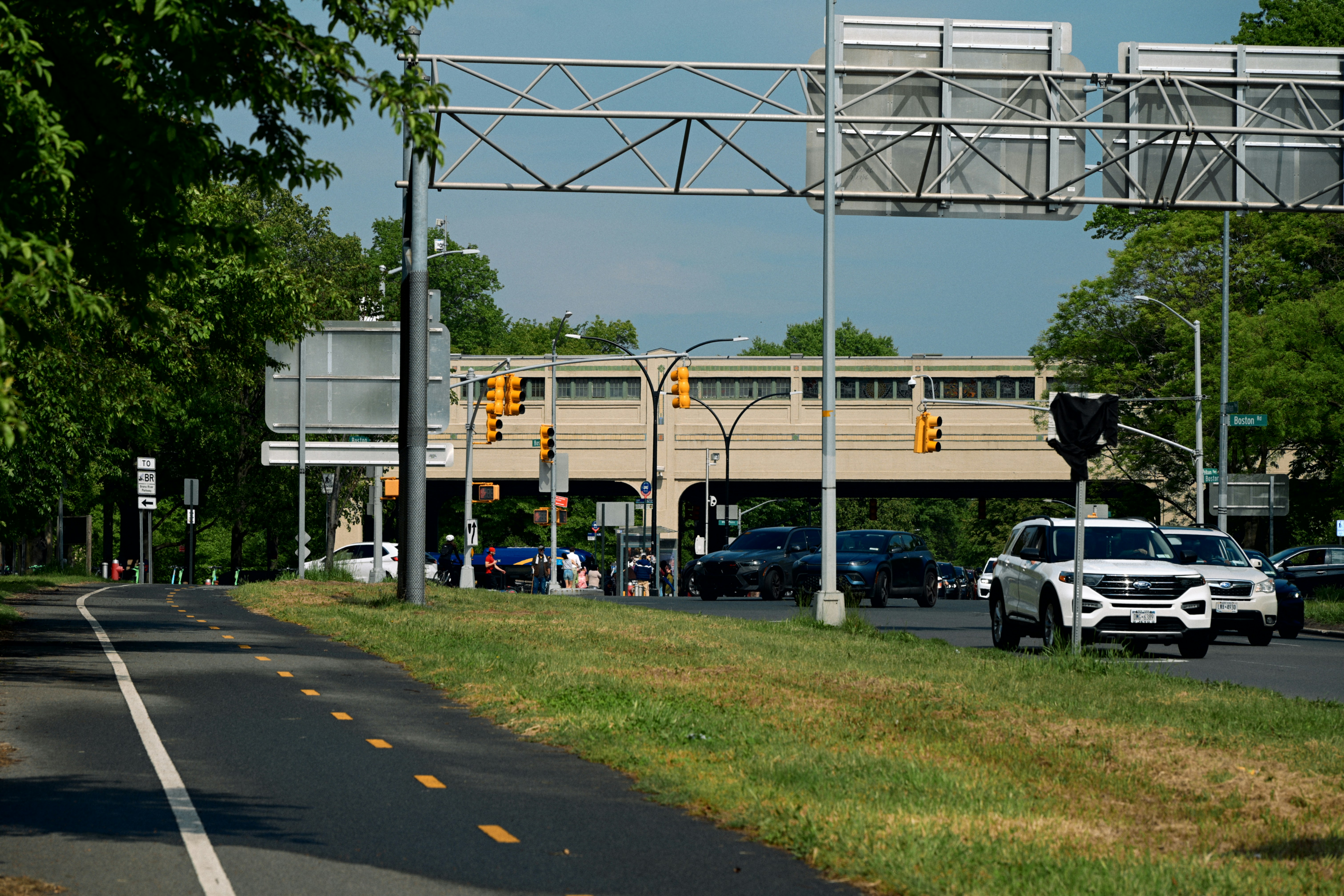 Traffic moving near an overpass with a bike lane.