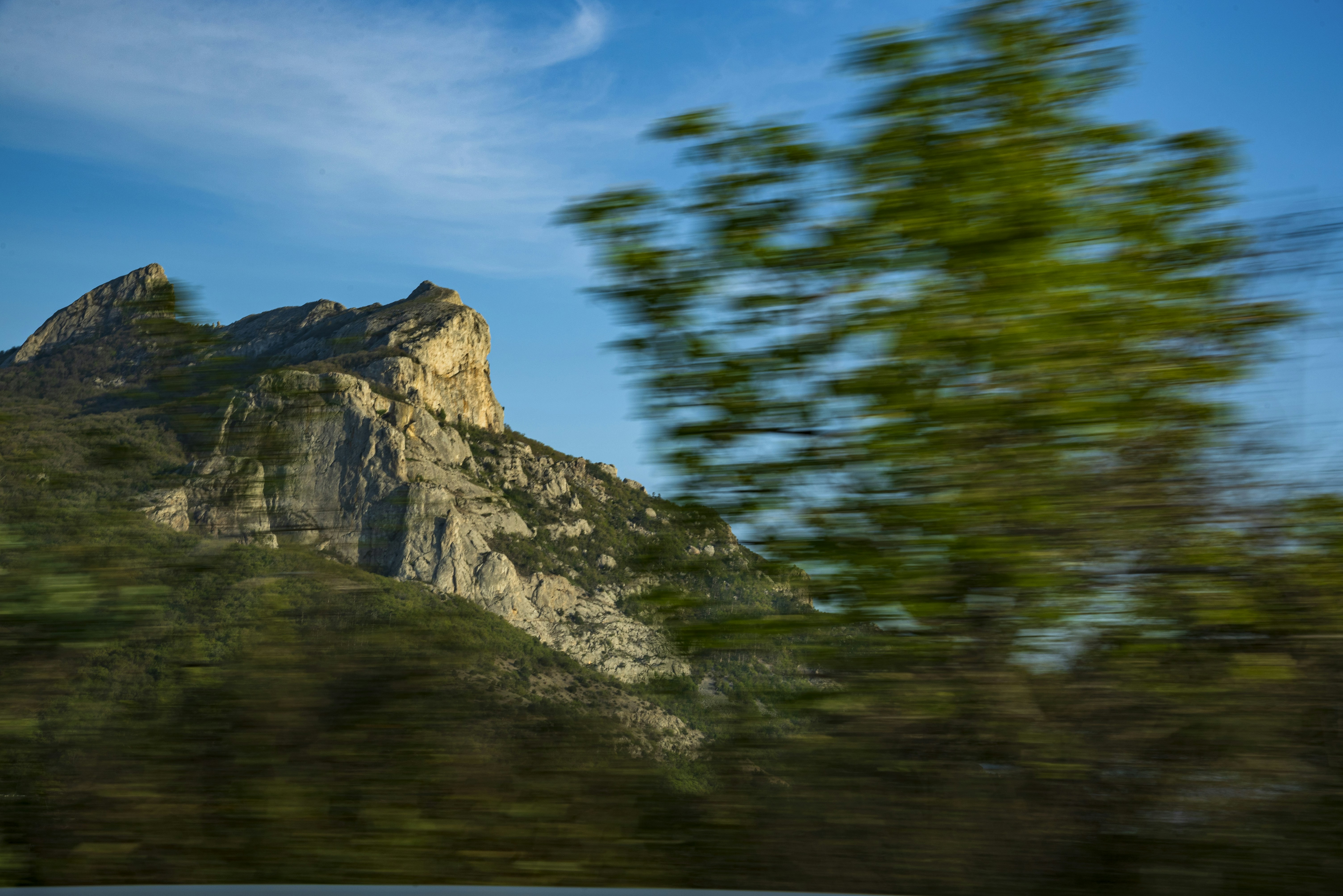 Rugged mountain landscape with blurred green foreground.